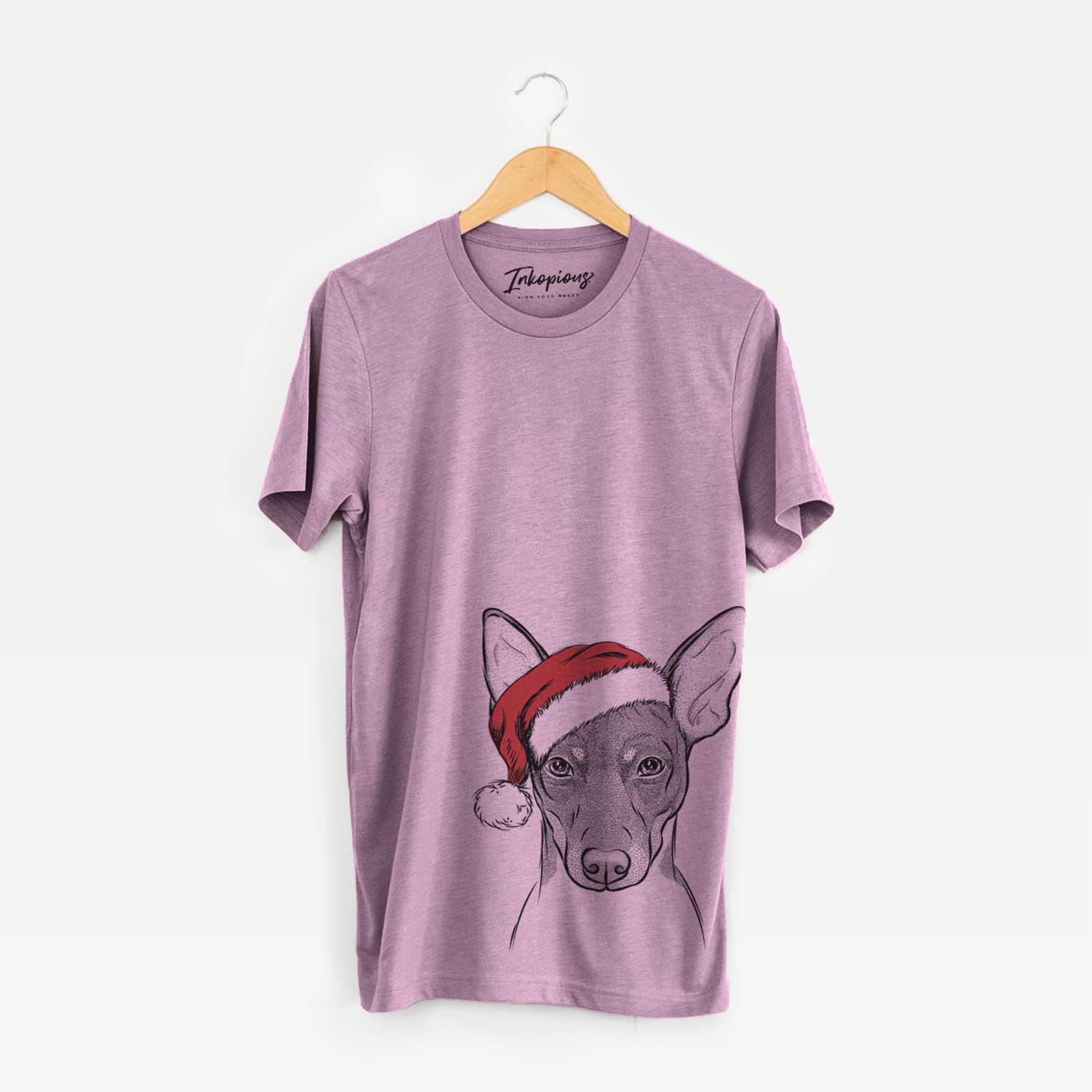 Hand-drawn sketch of Knox the Rat Terrier wearing a Santa hat on an Orchid Unisex crewneck
