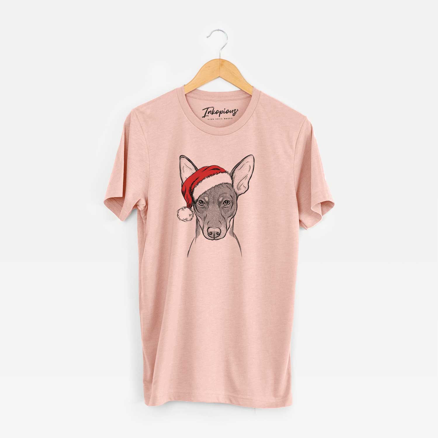 Hand-drawn sketch of Knox the Rat Terrier wearing a Santa hat on a Peach Unisex crewneck