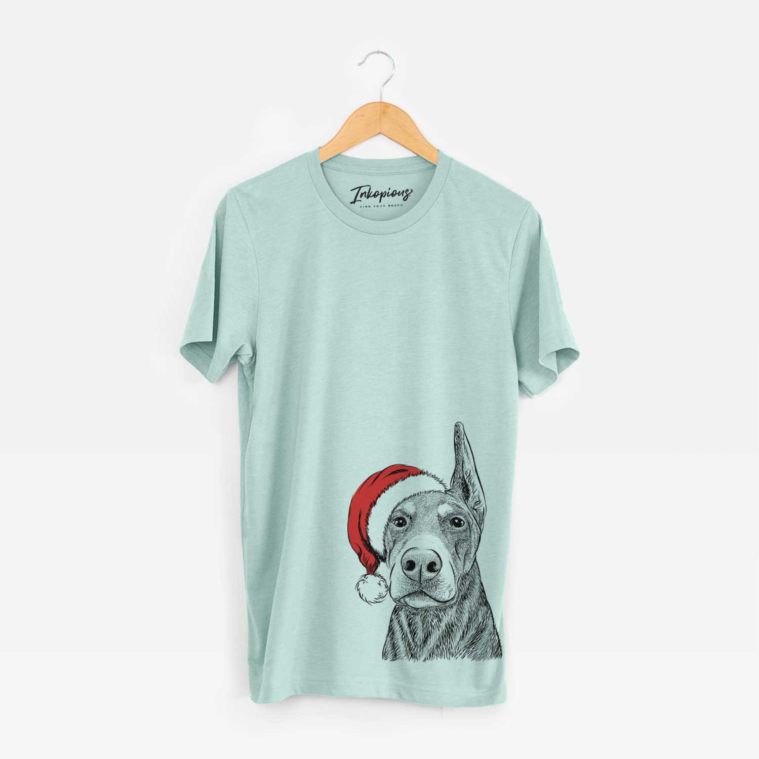 Hand-drawn sketch of Luna the Doberman Pinscher wearing a Santa hat on a Heather Sage Unisex crewneck