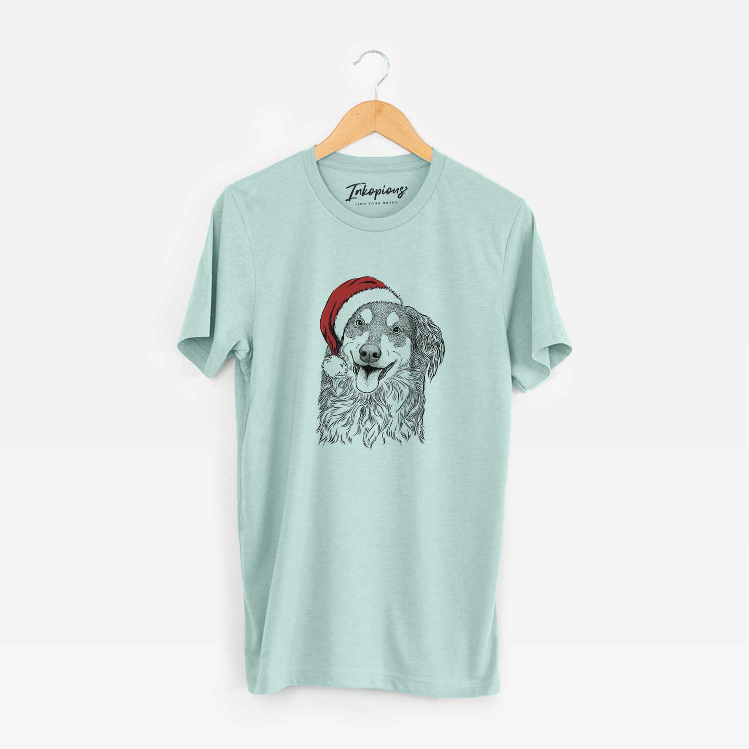 Hand-drawn sketch of Maddie the English Shepherd wearing a Santa hat on a Heather Sage Unisex crewneck