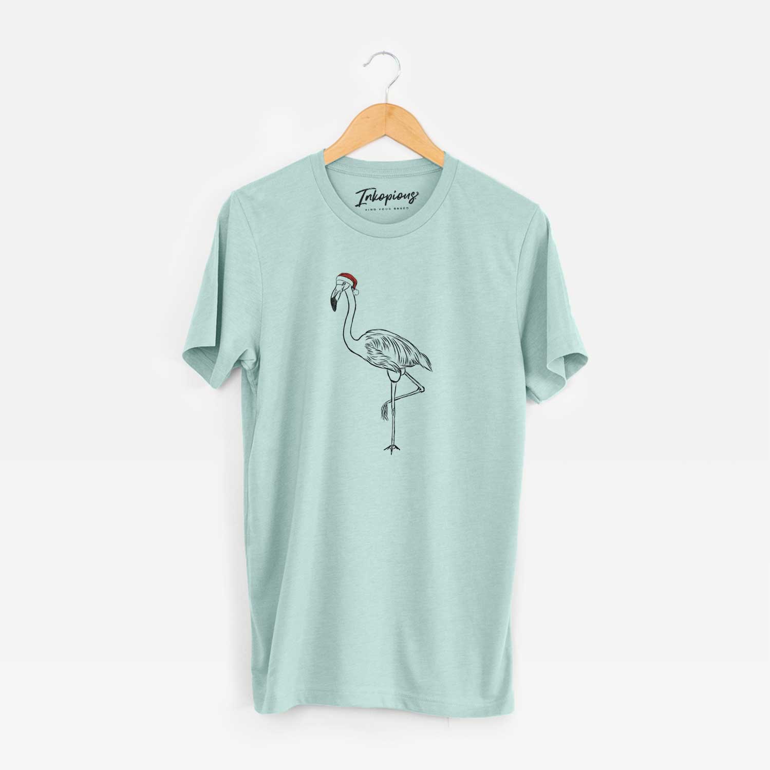 Hand-drawn sketch of Mango the Flamingo wearing a Santa hat on a Heather Sage Unisex crewneck