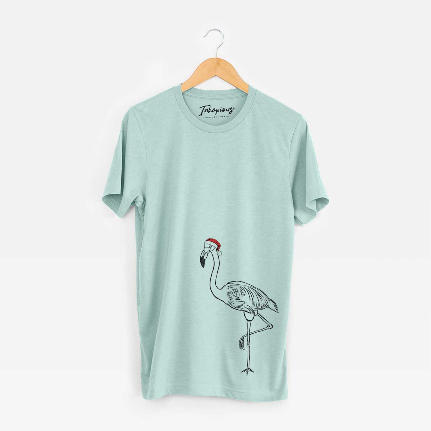 Hand-drawn sketch of Mango the Flamingo wearing a Santa hat on a Heather Sage Unisex crewneck