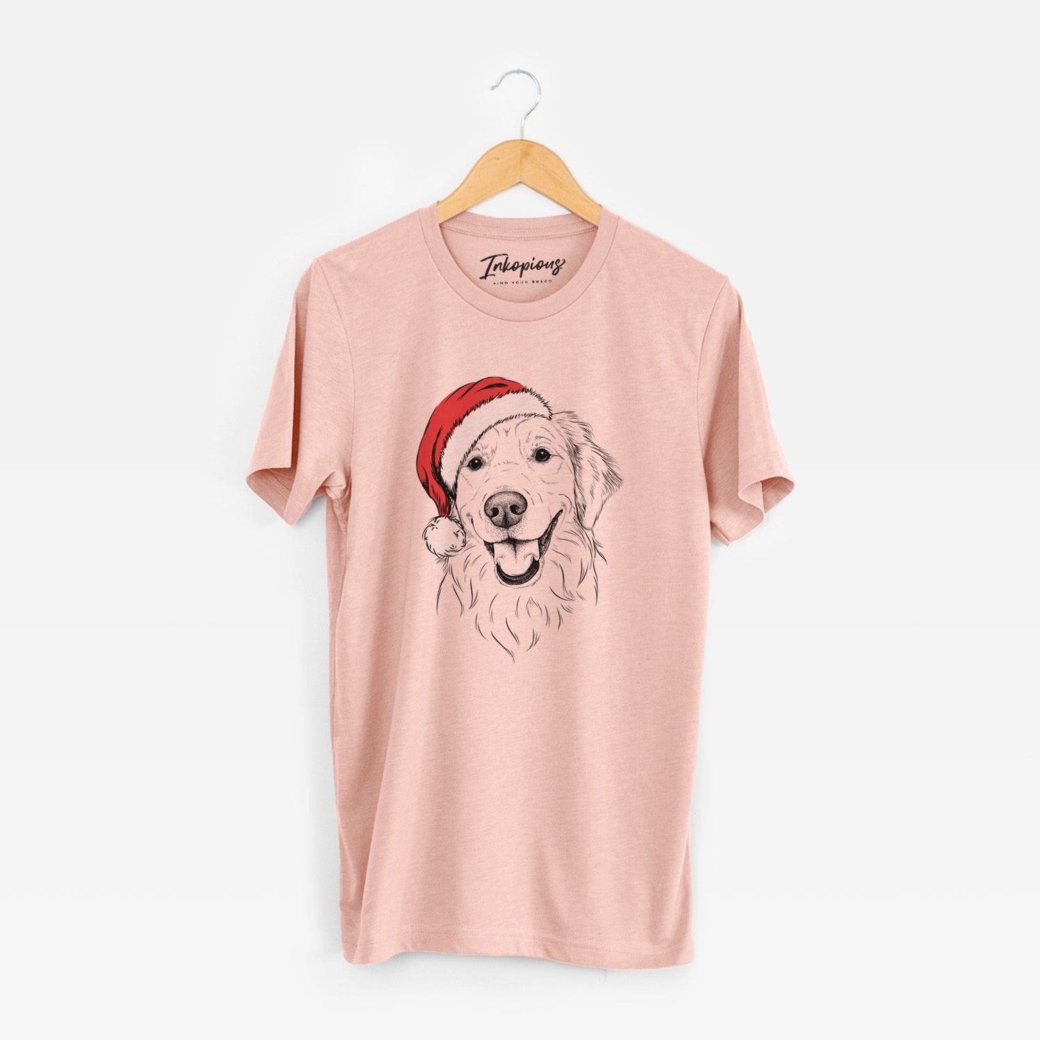 Hand-drawn sketch of Maple the Golden Retriever wearing a Santa hat on a Peach Unisex crewneck