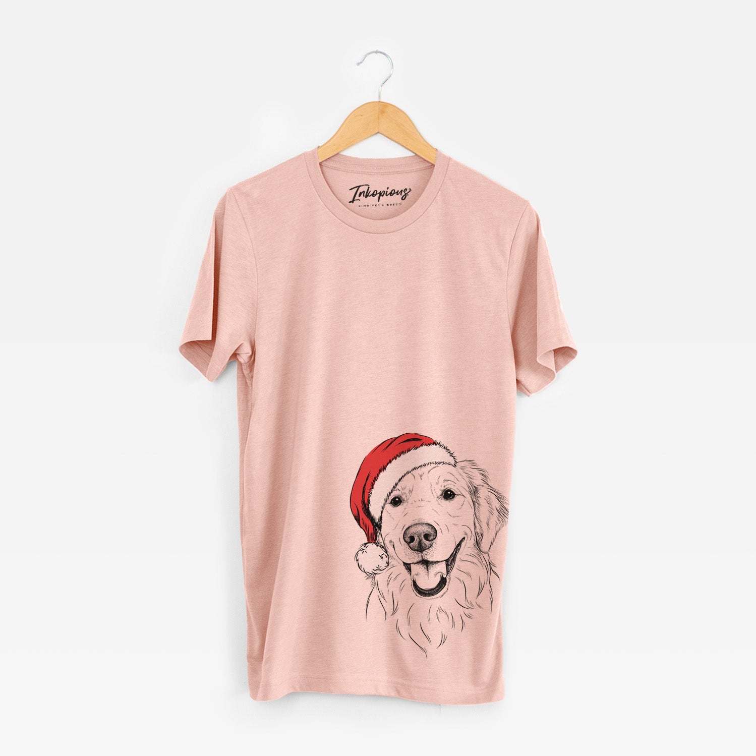 Hand-drawn sketch of Maple the Golden Retriever wearing a Santa hat on a Peach Unisex crewneck