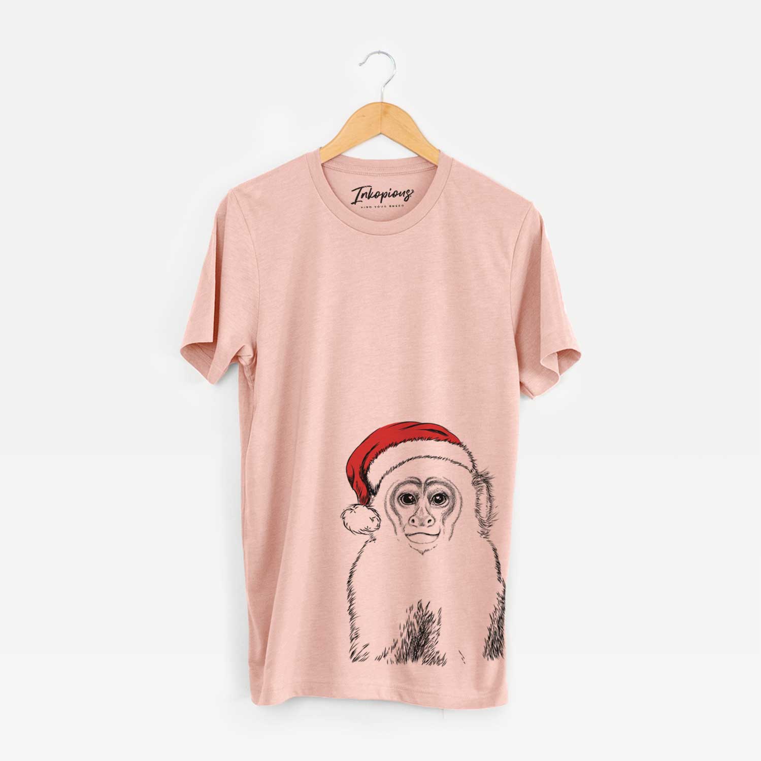 Hand-drawn sketch of Marcel the Capuchin Monkey wearing a Santa hat on a Peach Unisex crewneck