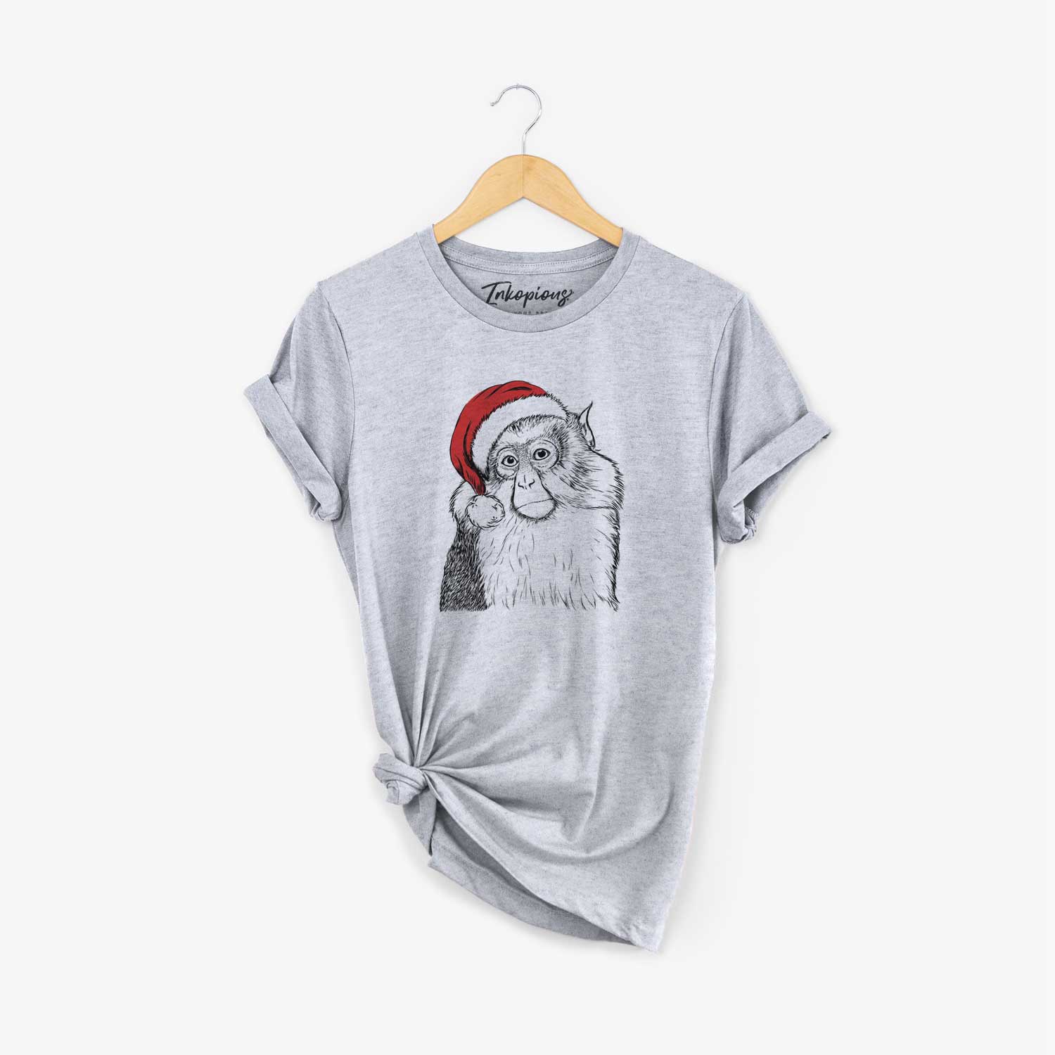 Hand-drawn sketch of Matata the Mona Monkey wearing a Santa hat on a Grey Unisex crewneck