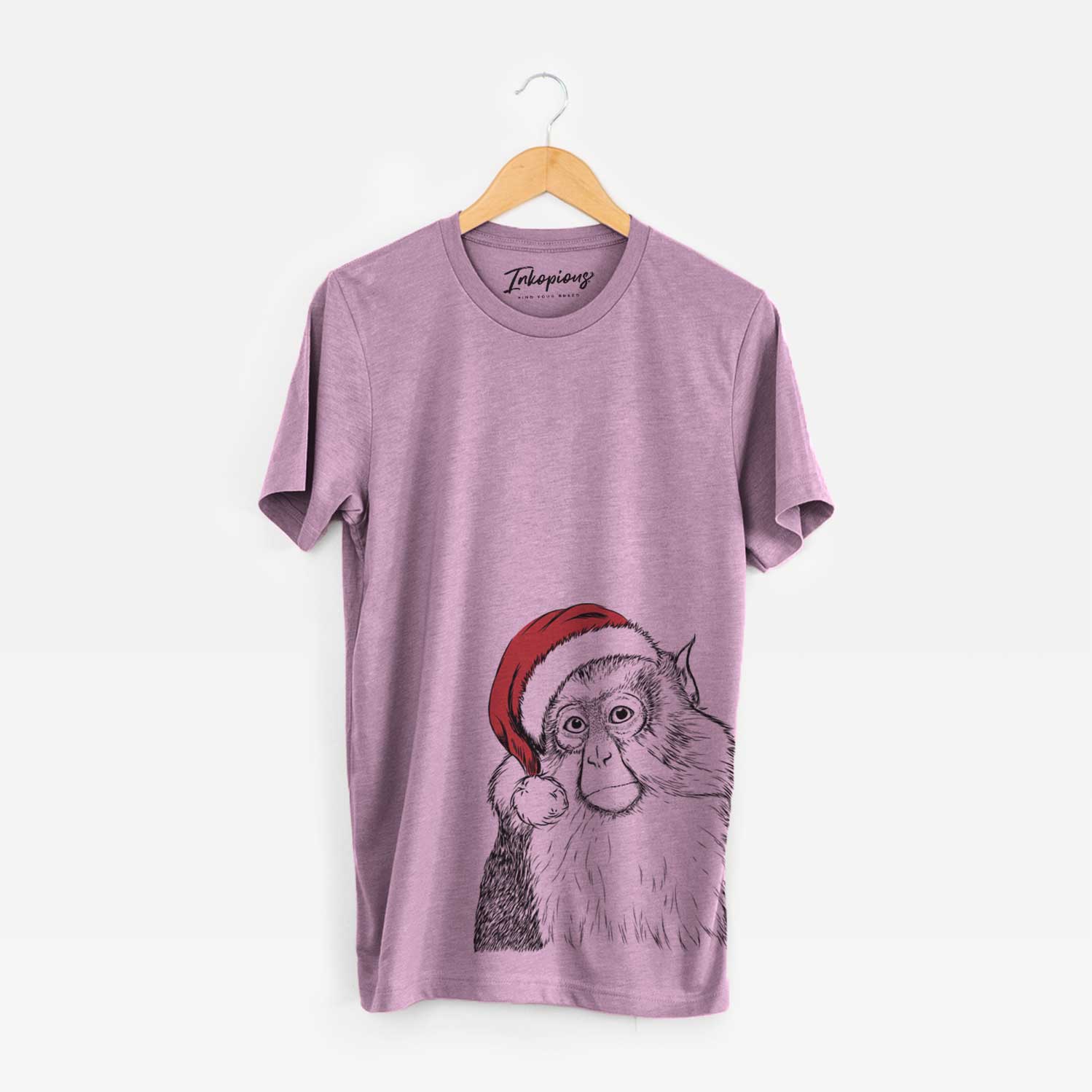 Hand-drawn sketch of Matata the Mona Monkey wearing a Santa hat on an Orchid Unisex crewneck