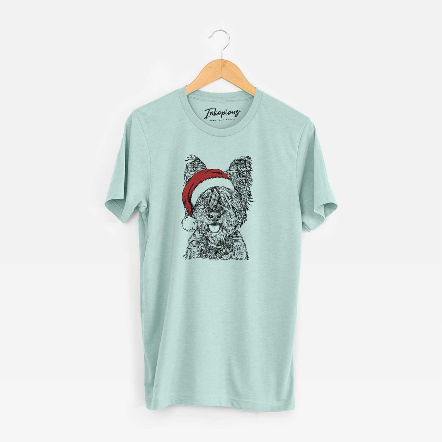 Hand-drawn sketch of McDuff the Cairn Terrier wearing a Santa hat on a Heather Sage Unisex crewneck