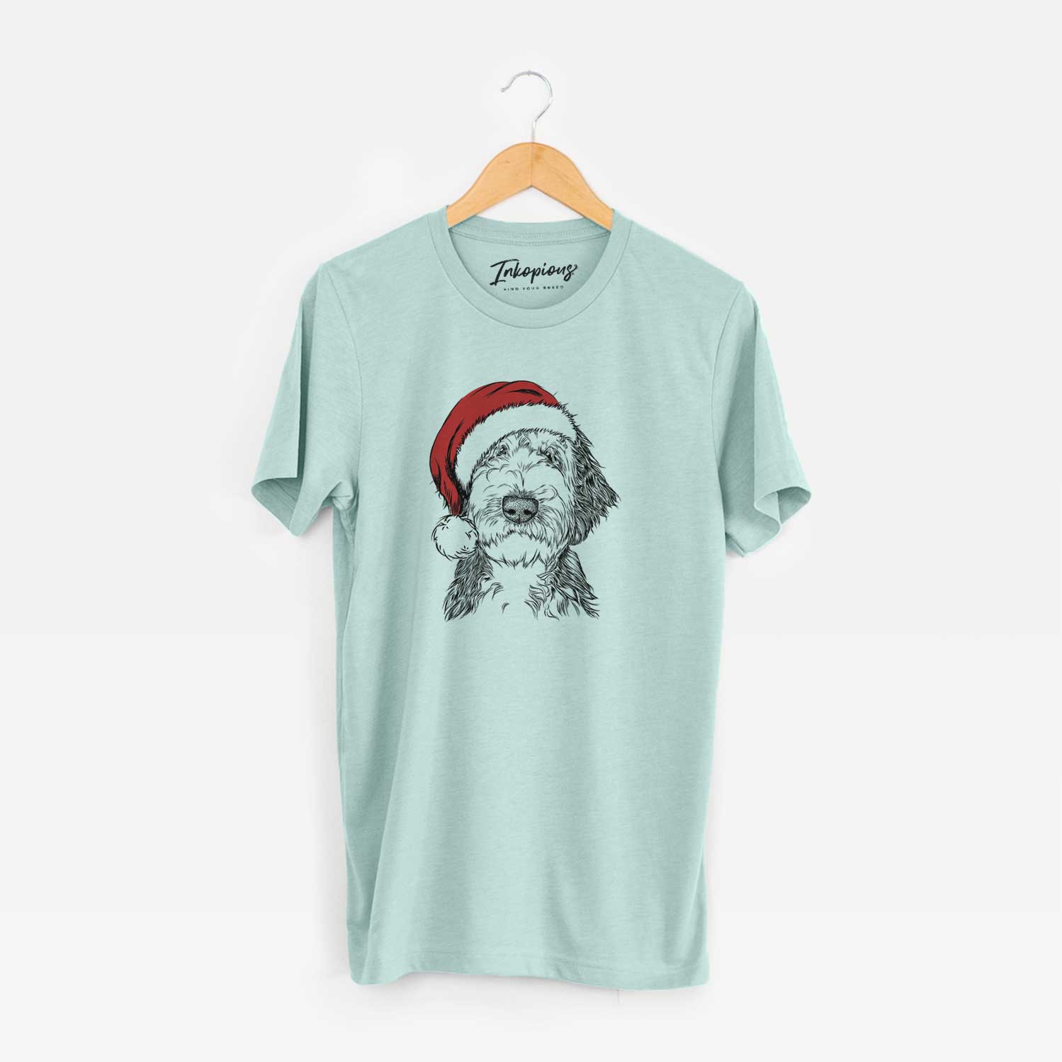 Hand-drawn sketch of Milo Fluff the Sheepadoodle wearing a Santa hat on a Heather Sage Unisex crewneck