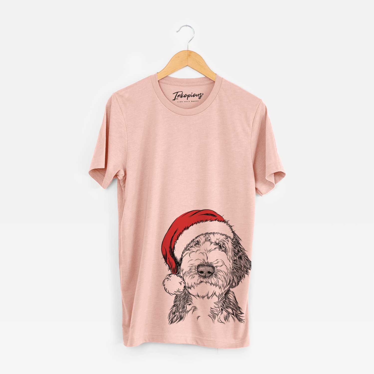 Hand-drawn sketch of Milo Fluff the Sheepadoodle wearing a Santa hat on a Peach Unisex crewneck