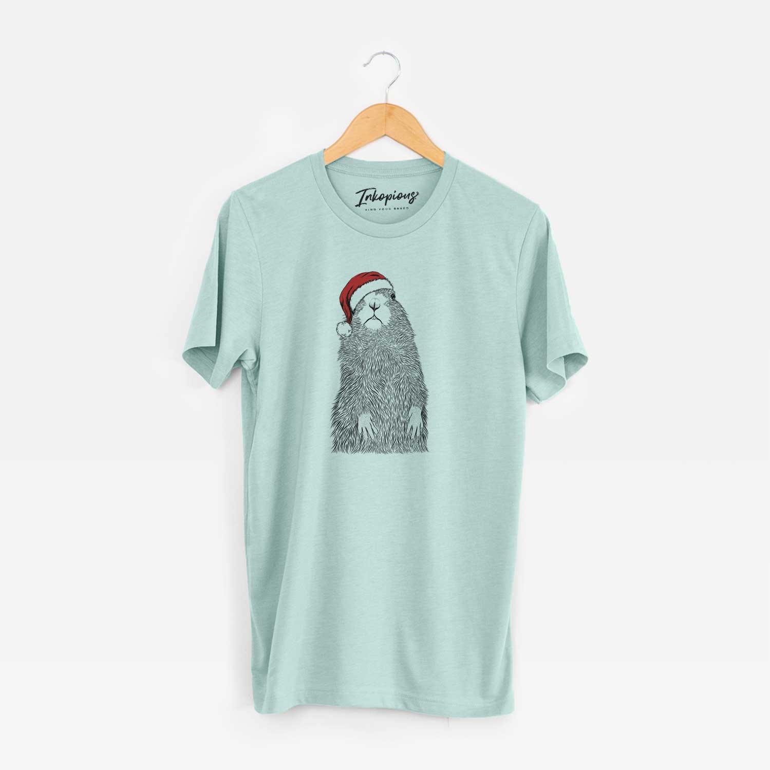 Hand-drawn sketch of Mr. Otis the Prairie Dog wearing a Santa hat on a Heather Sage Unisex crewneck