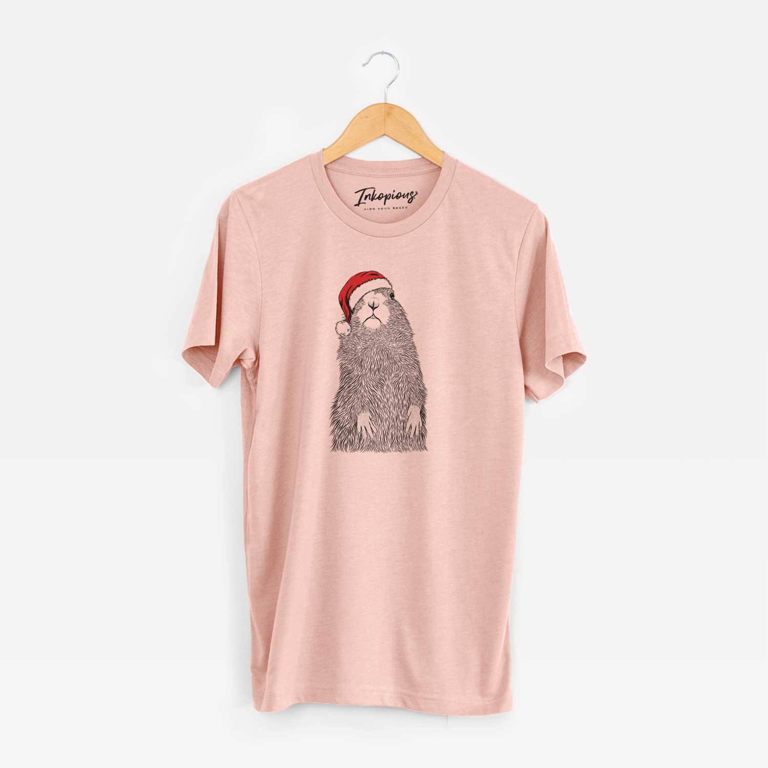 Hand-drawn sketch of Mr. Otis the Prairie Dog wearing a Santa hat on a Peach Unisex crewneck