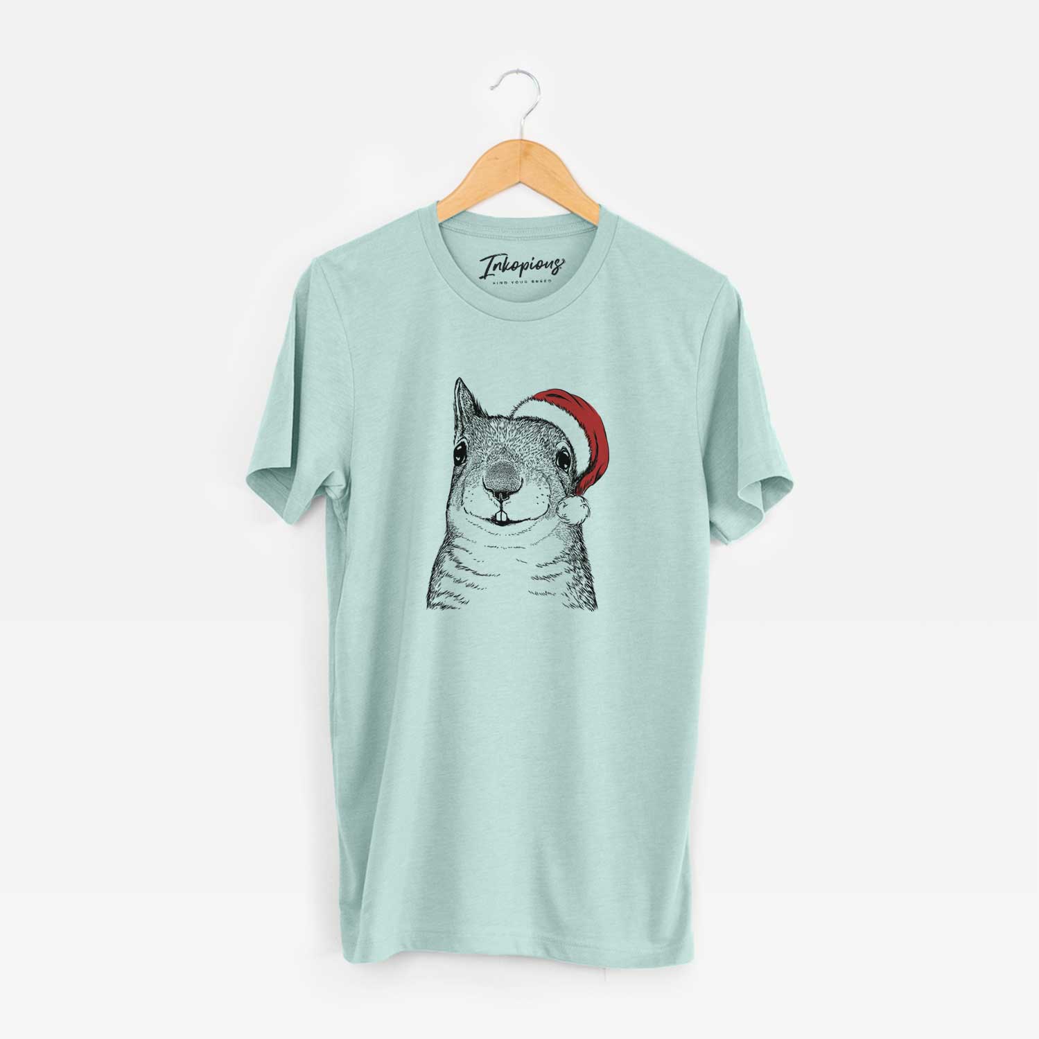 Hand-drawn sketch of Nibbles the Squirrel wearing a Santa hat on a Heather Sage Unisex crewneck