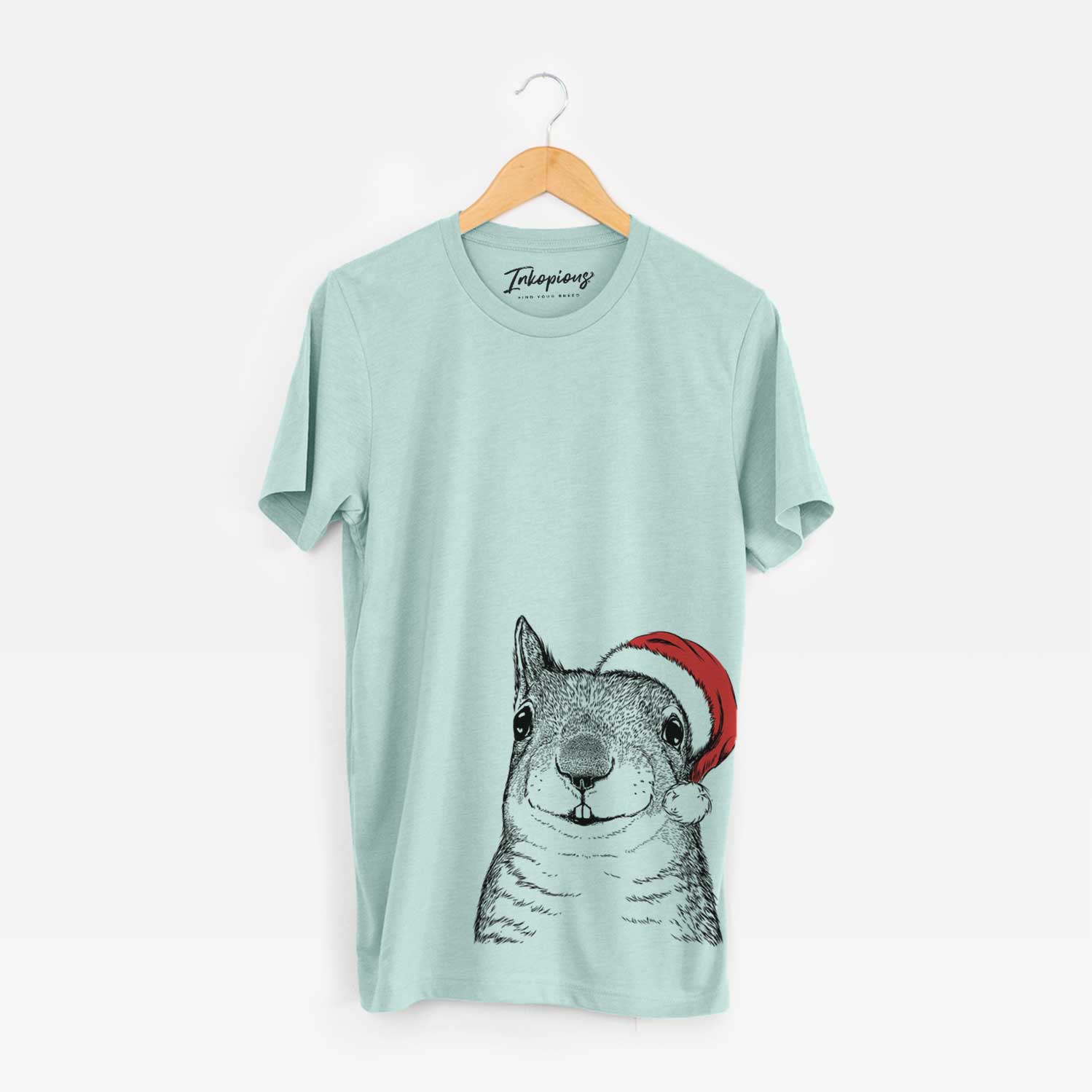 Hand-drawn sketch of Nibbles the Squirrel wearing a Santa hat on a Heather Sage Unisex crewneck