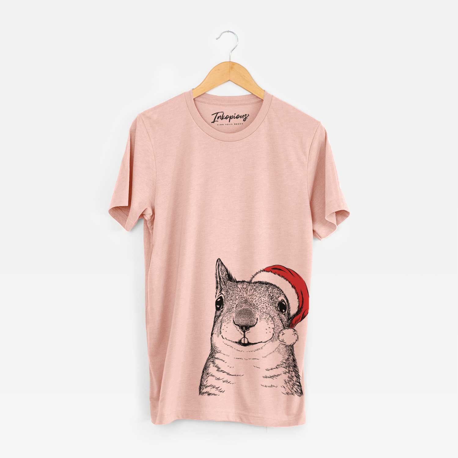 Hand-drawn sketch of Nibbles the Squirrel wearing a Santa hat on a Peach Unisex crewneck