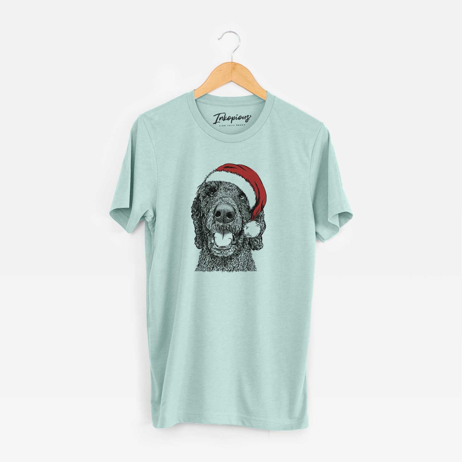 Hand-drawn sketch of Obi James the Goldendoodle wearing a Santa hat on a Heather Sage Unisex crewneck