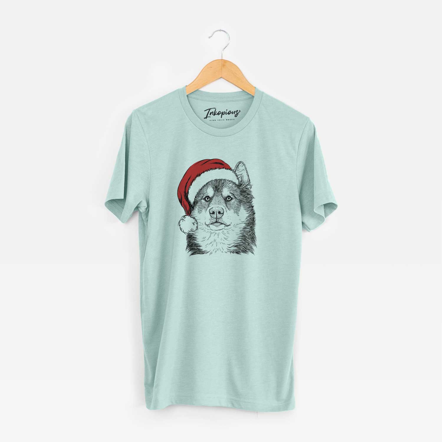Hand-drawn sketch of Oskar the Canadian Eskimo Dog wearing a Santa hat on a Heather Sage Unisex crewneck