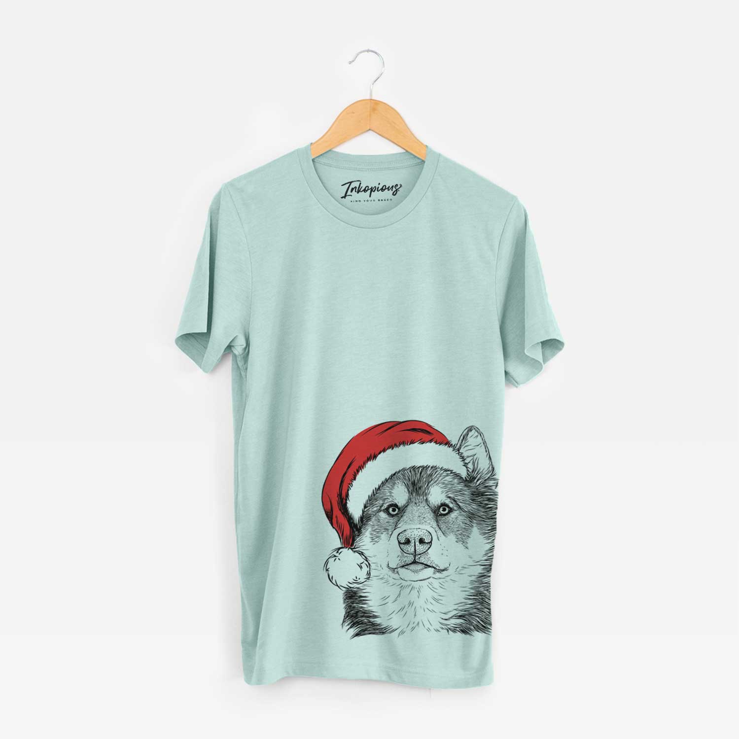 Hand-drawn sketch of Oskar the Canadian Eskimo Dog wearing a Santa hat on a Heather Sage Unisex crewneck