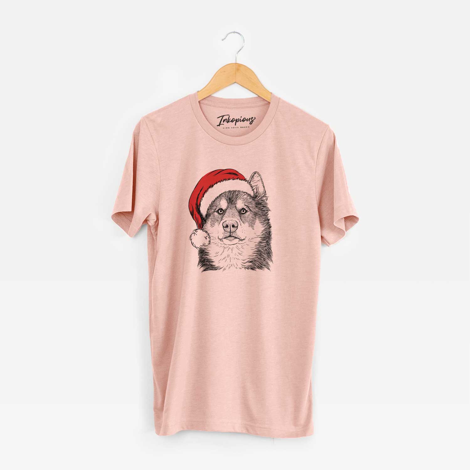 Hand-drawn sketch of Oskar the Canadian Eskimo Dog wearing a Santa hat on a Peach Unisex crewneck