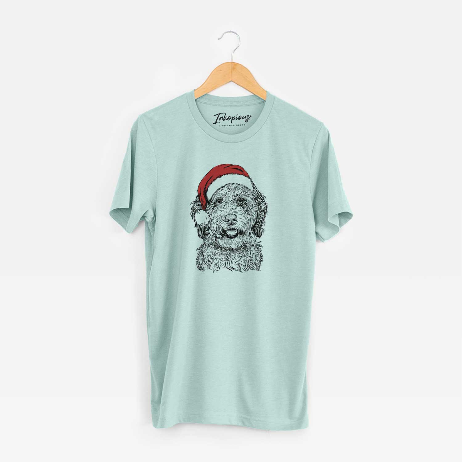 Hand-drawn sketch of Palmer the Aussiedoodle wearing a Santa hat on a Heather Sage Unisex crewneck