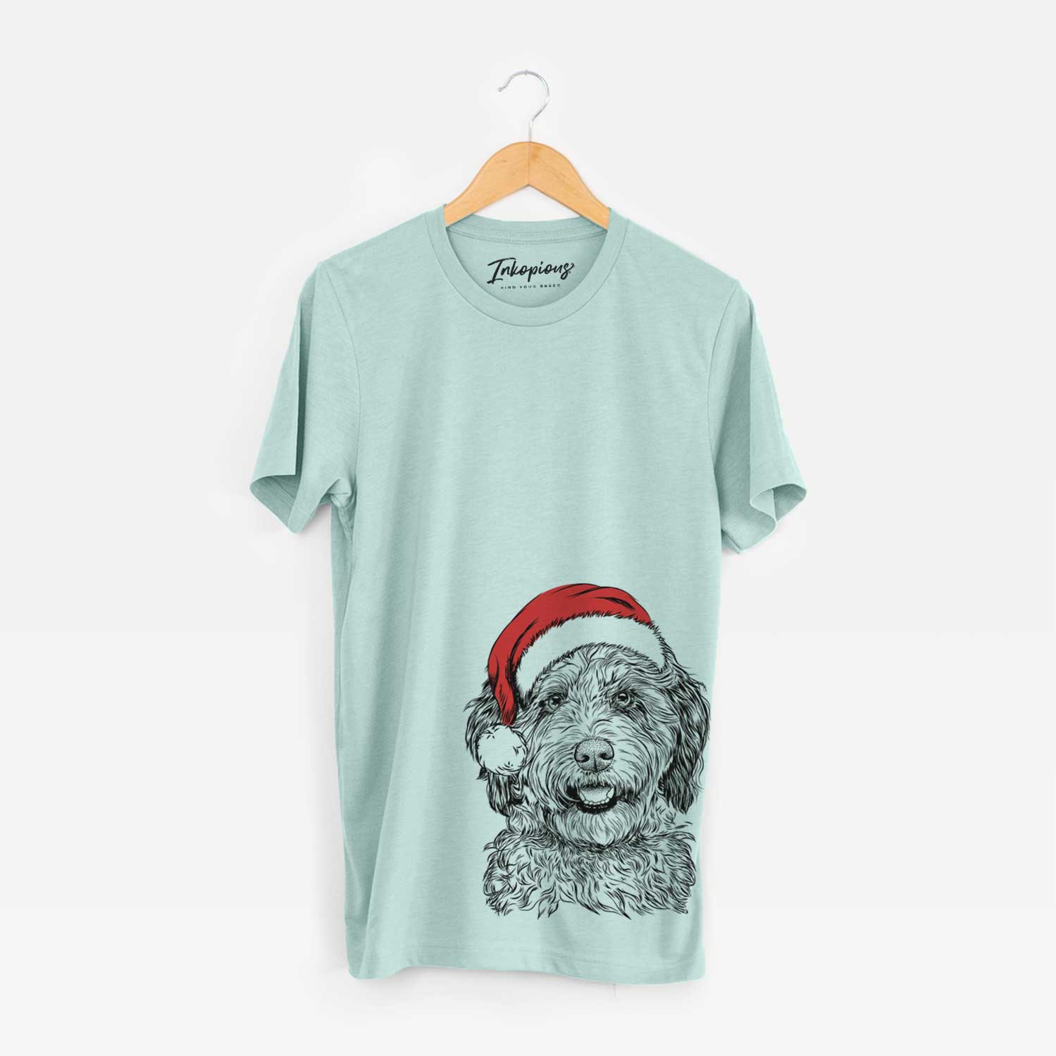 Hand-drawn sketch of Palmer the Aussiedoodle wearing a Santa hat on a Heather Sage Unisex crewneck
