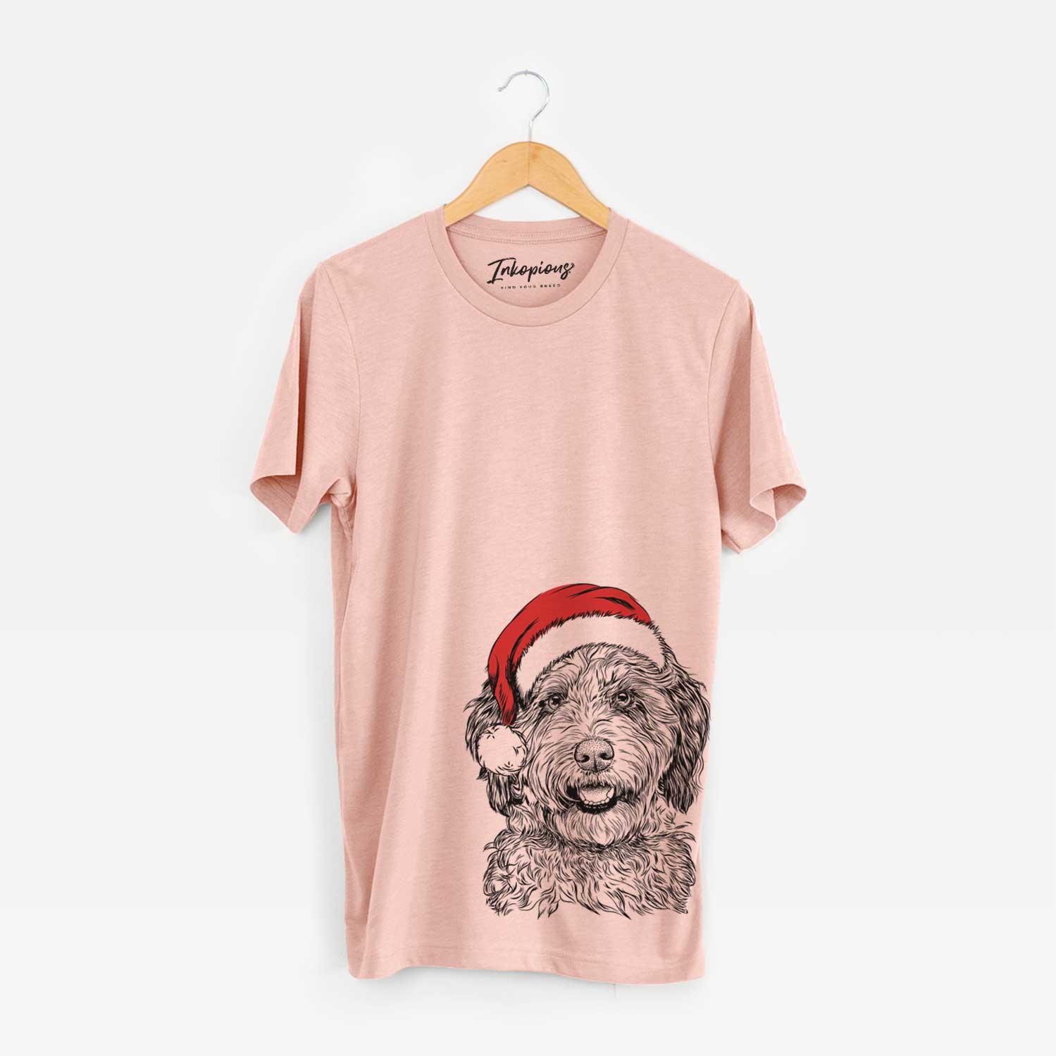 Hand-drawn sketch of Palmer the Aussiedoodle wearing a Santa hat on a Peach Unisex crewneck