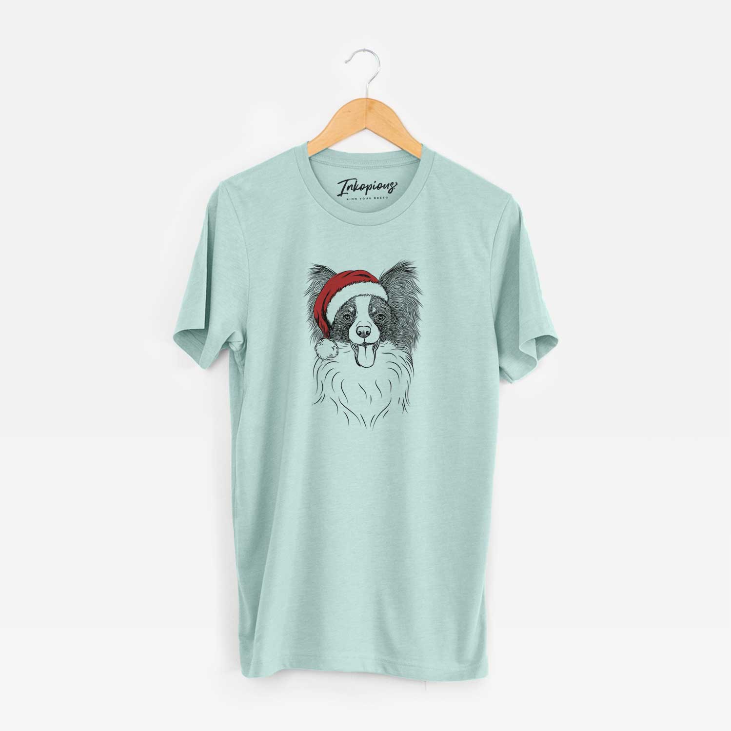 Hand-drawn sketch of Patrick the Papillon wearing a Santa hat on a Heather Sage Unisex crewneck