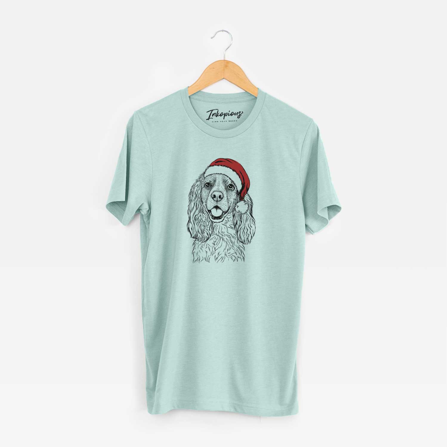 Hand-drawn sketch of Perry the Cockalier wearing a Santa hat on a Heather Sage Unisex crewneck