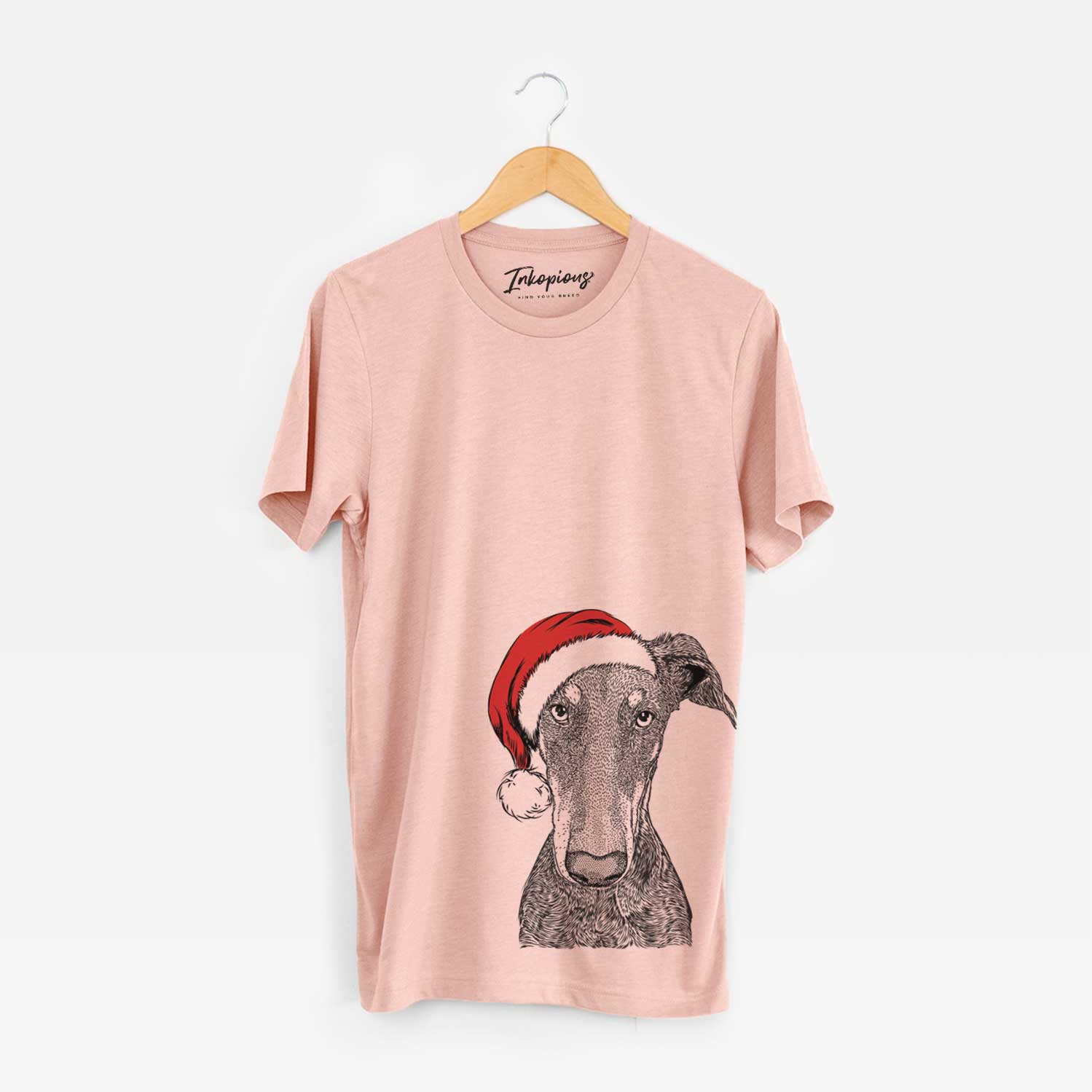 Hand-drawn sketch of Princess Fiona the Doberman Pinscher wearing a Santa hat on a Peach Unisex crewneck