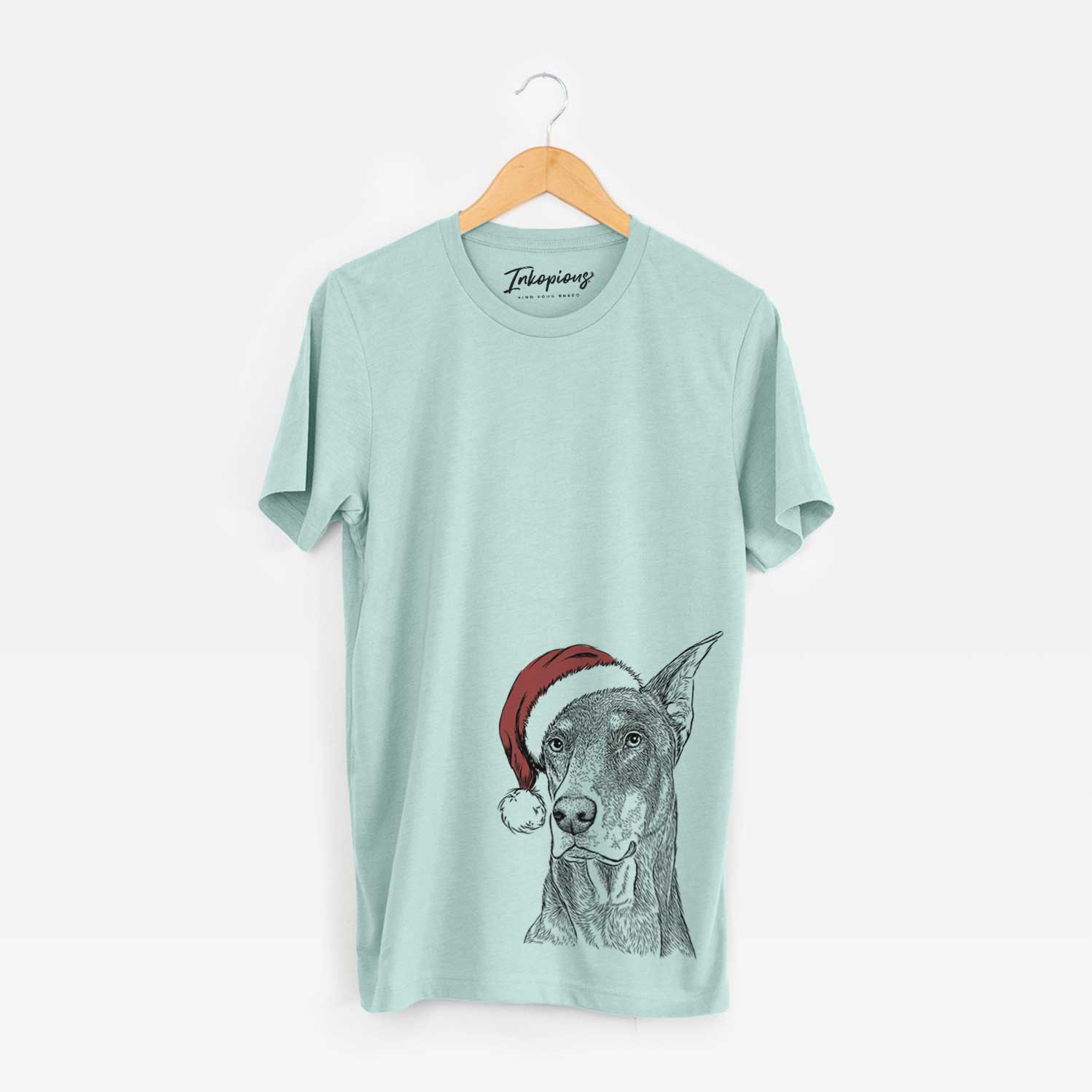 Hand-drawn sketch of RJ the Doberman Pinscher wearing a Santa hat on a Heather Sage Unisex crewneck