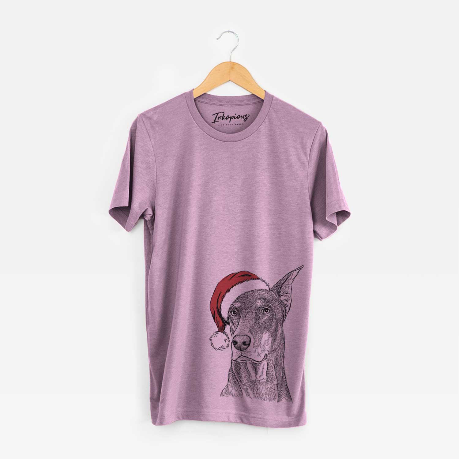 Hand-drawn sketch of RJ the Doberman Pinscher wearing a Santa hat on an Orchid Unisex crewneck