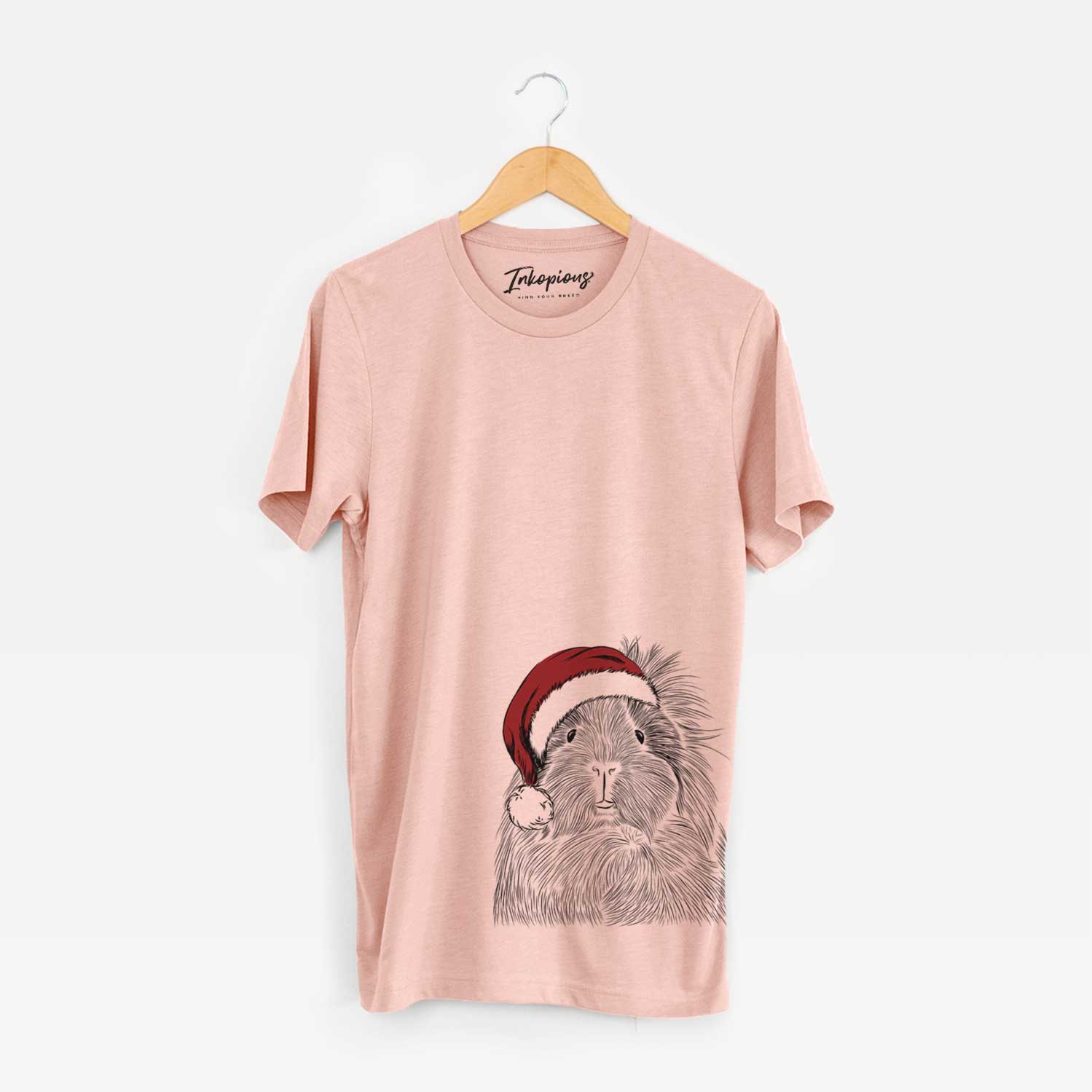 Hand-drawn sketch of Rhino the Guinea Pig wearing a Santa hat on a Peach Unisex crewneck