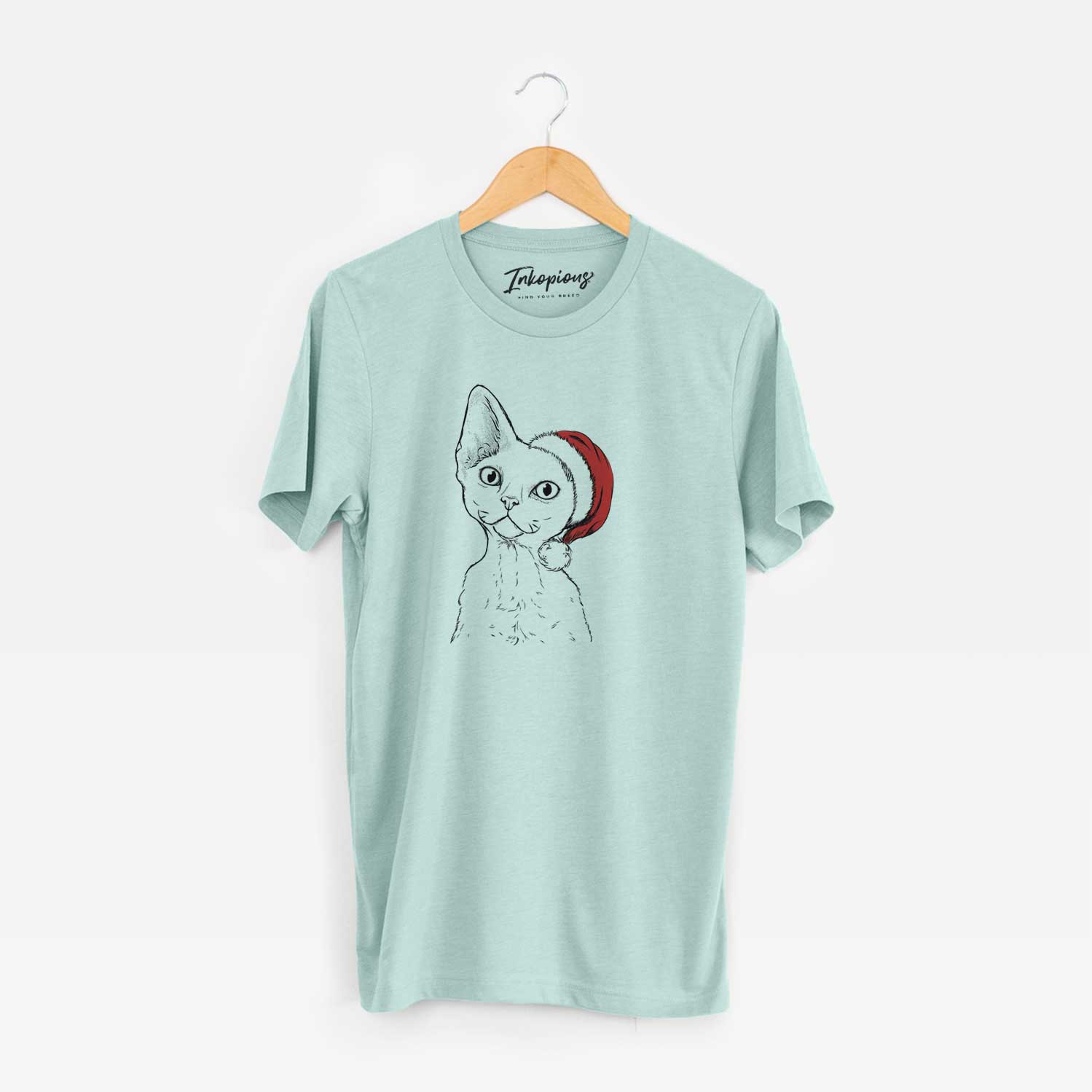 Hand-drawn sketch of Ripley the Devon Rex Cat wearing a Santa hat on a Heather Sage Unisex crewneck