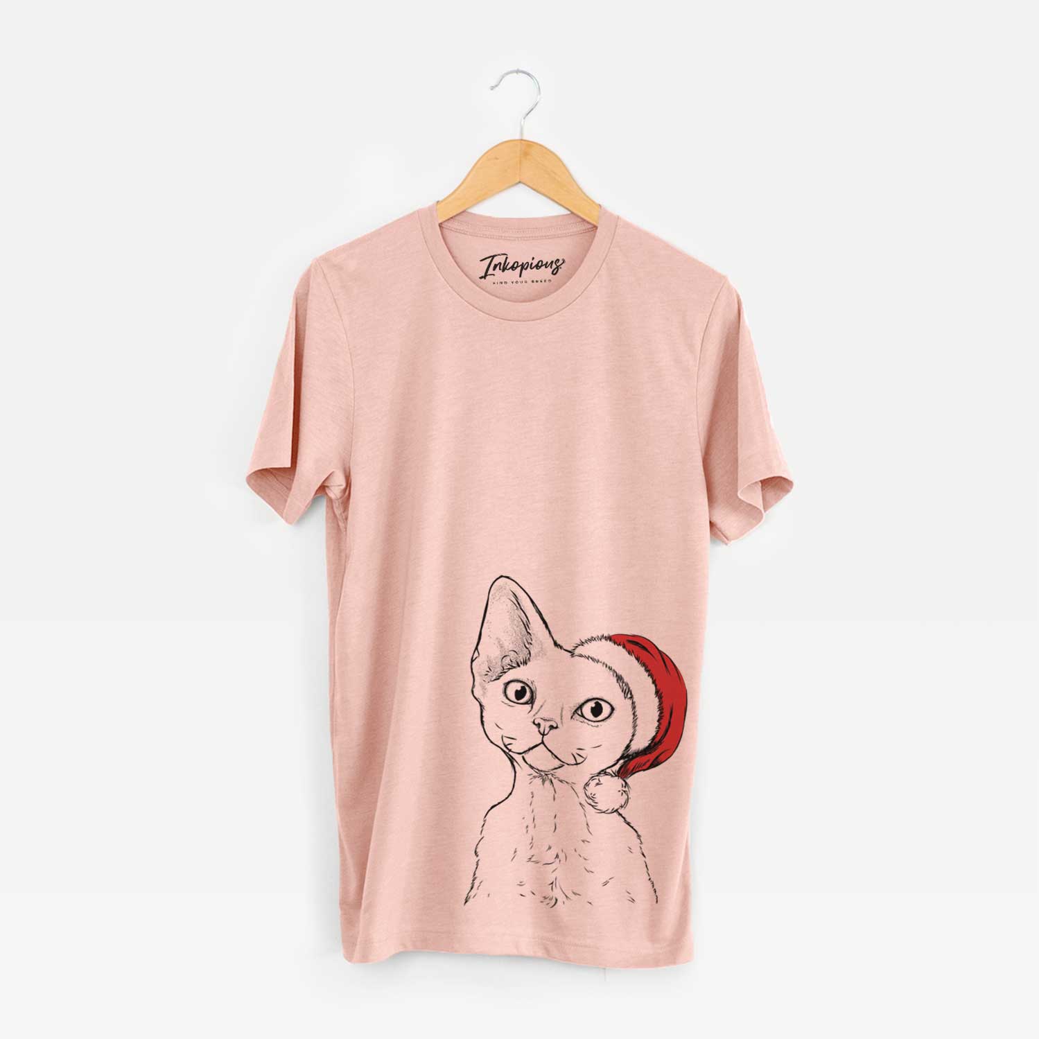 Hand-drawn sketch of Ripley the Devon Rex Cat wearing a Santa hat on a Peach Unisex crewneck