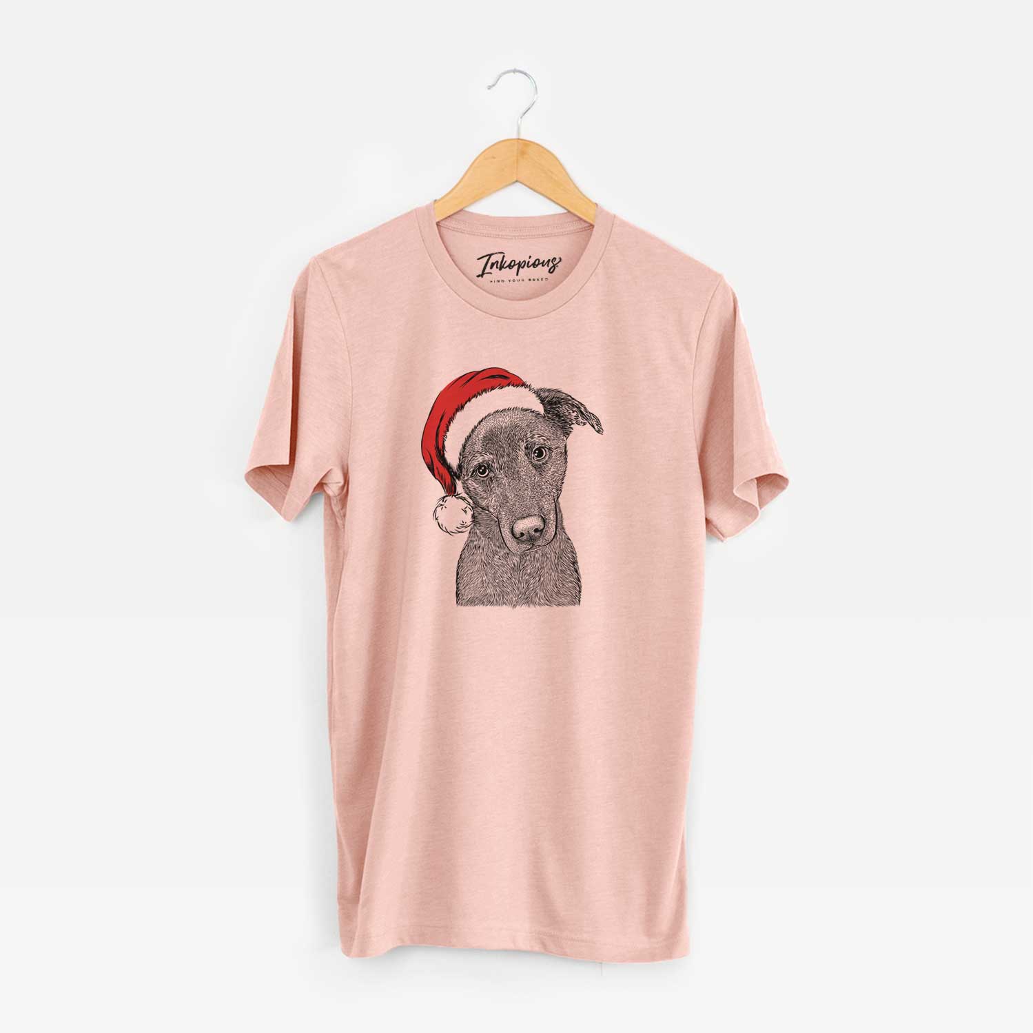 Hand-drawn sketch of Sadie the Whipador wearing a Santa hat on a Peach Unisex crewneck