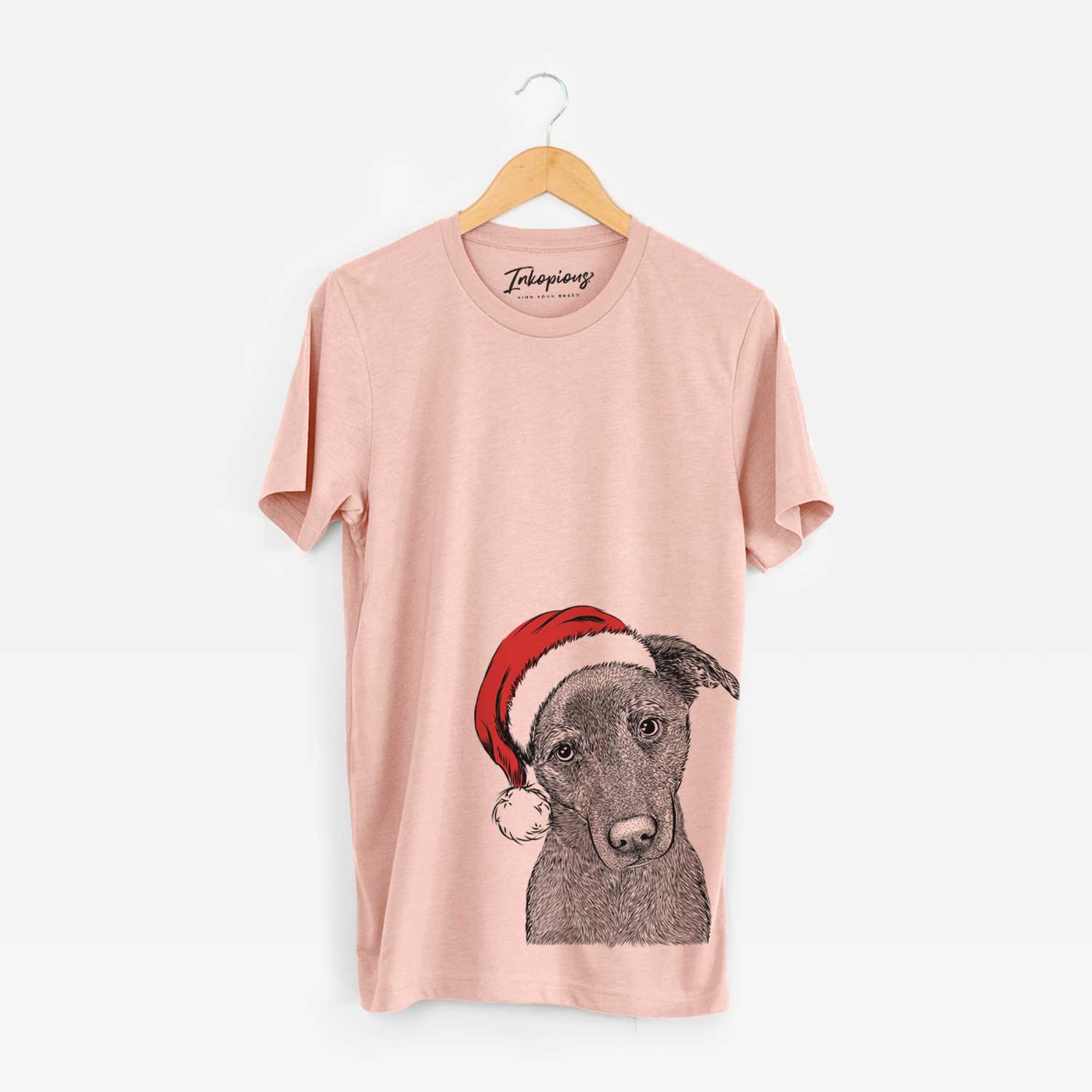 Hand-drawn sketch of Sadie the Whipador wearing a Santa hat on a Peach Unisex crewneck