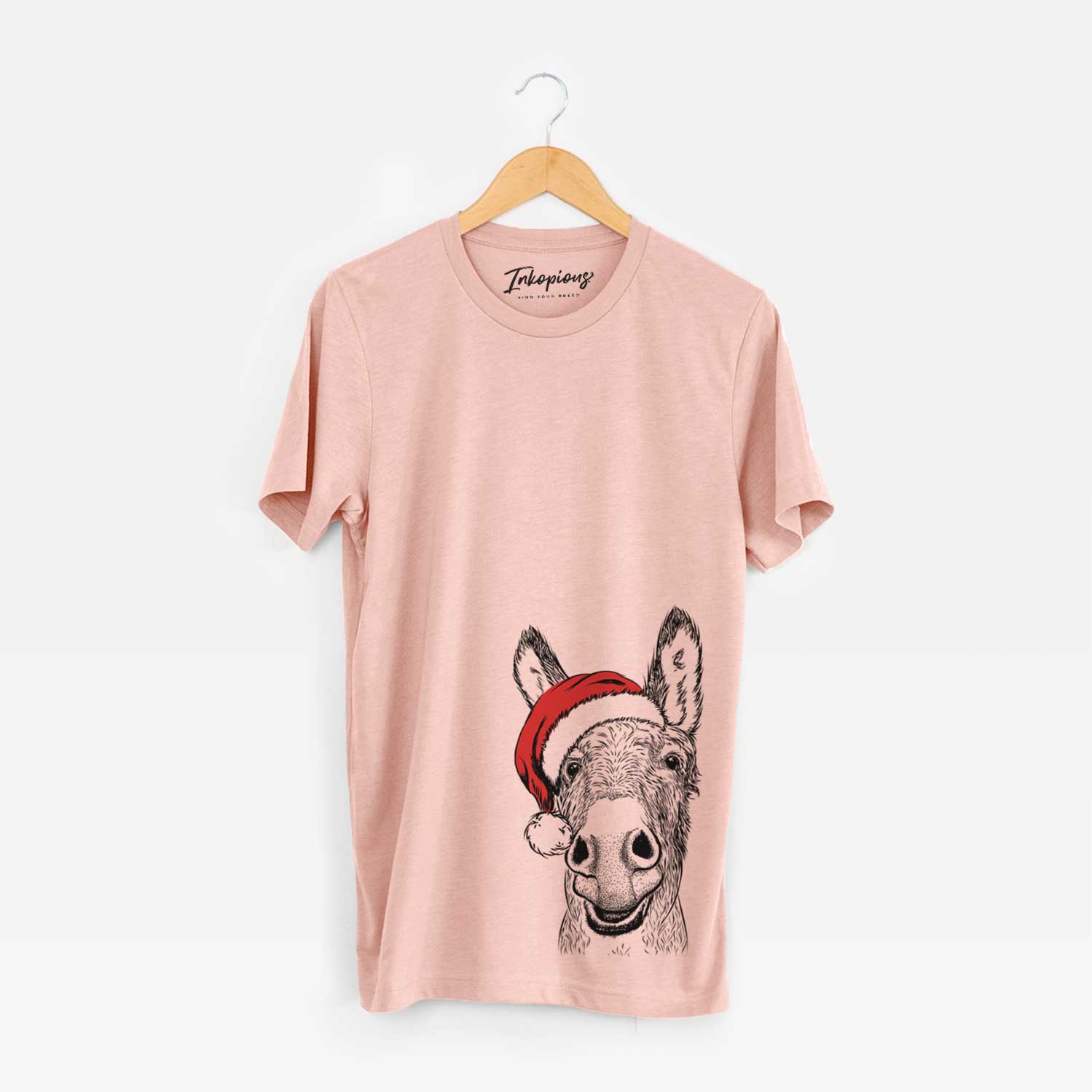 Hand-drawn sketch of Samule the Donkey wearing a Santa hat on a Peach Unisex crewneck