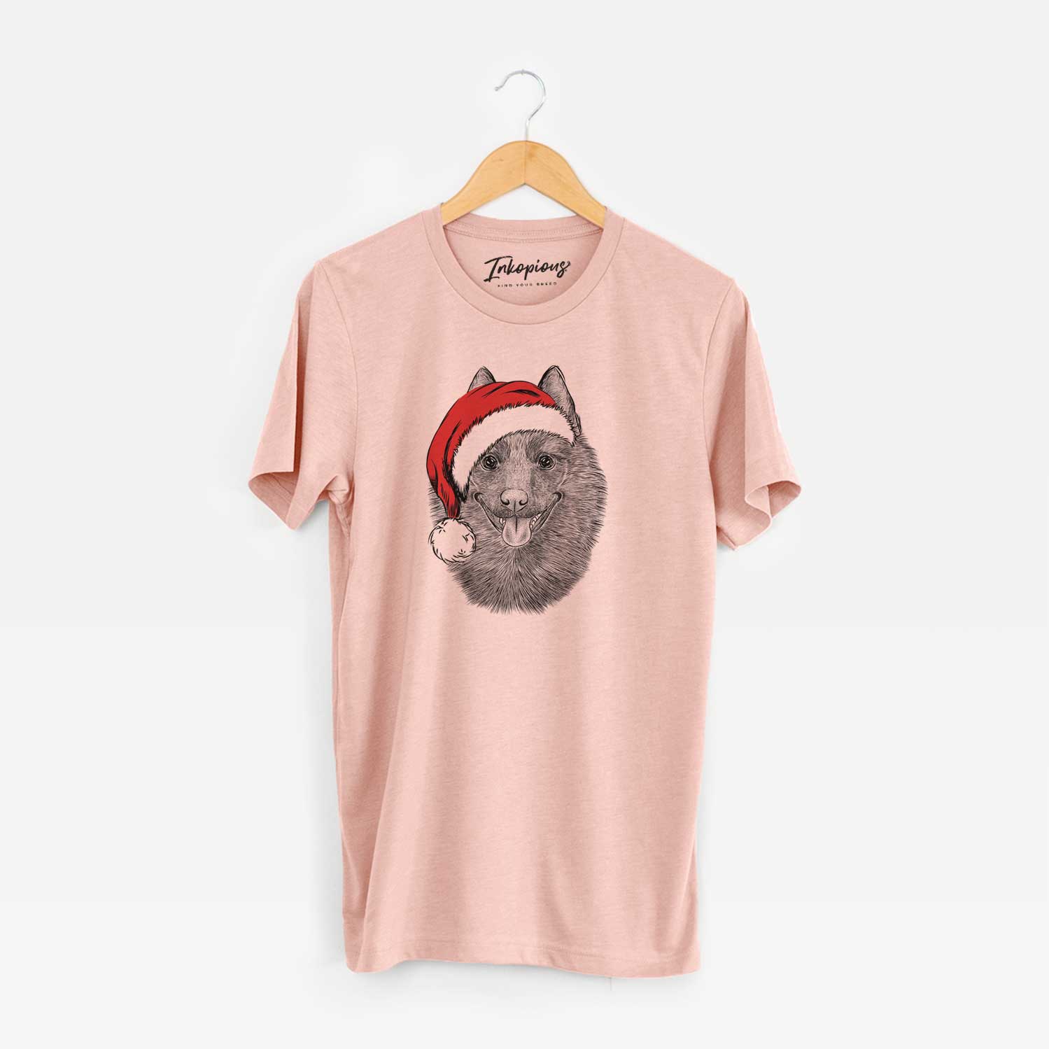 Hand-drawn sketch of Sander the Schipperke wearing a Santa hat on a Peach Unisex crewneck