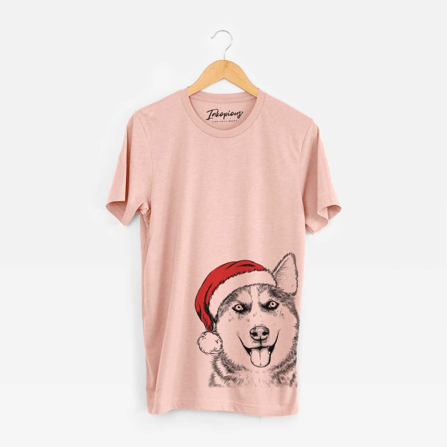 Hand-drawn sketch of Sesi the Siberian Husky wearing a Santa hat on a Peach Unisex crewneck