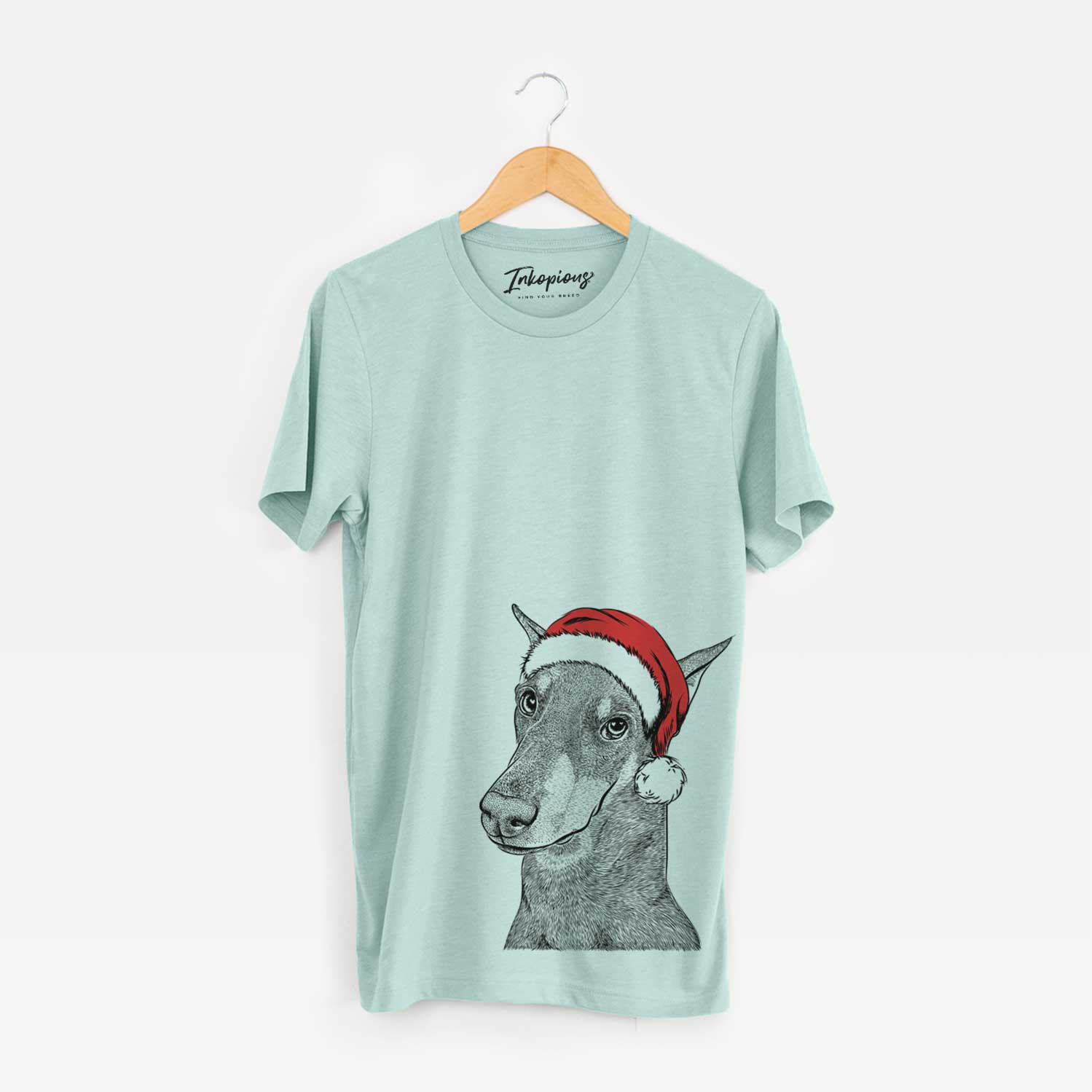 Hand-drawn sketch of Shelby the Doberman Pinscher wearing a Santa hat on a Heather Sage Unisex crewneck