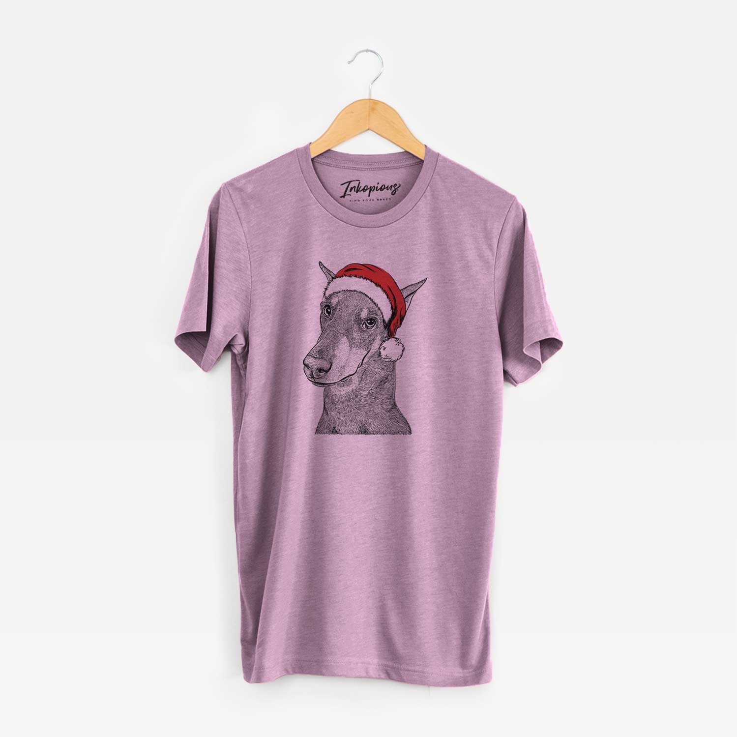 Hand-drawn sketch of Shelby the Doberman Pinscher wearing a Santa hat on an Orchid Unisex crewneck