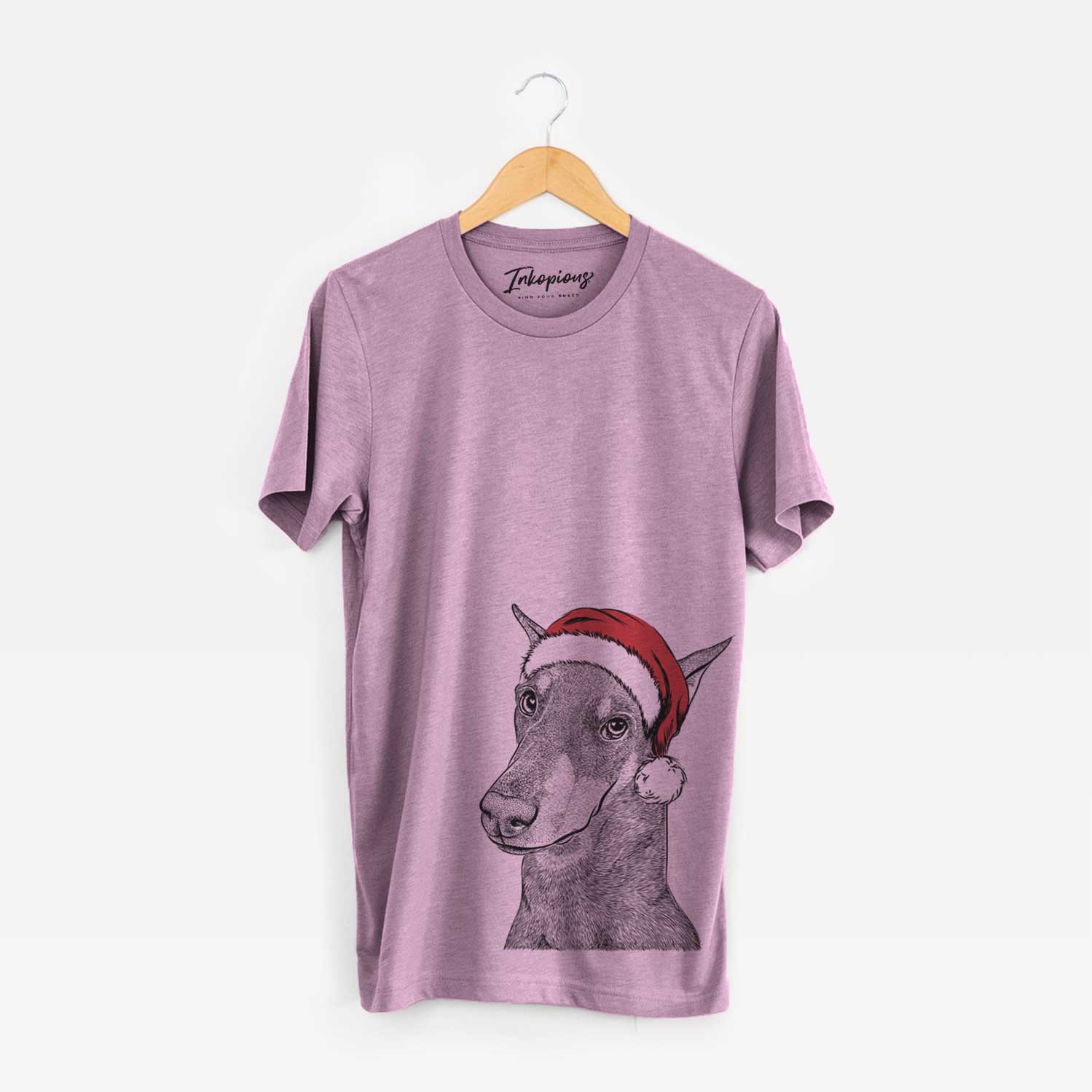 Hand-drawn sketch of Shelby the Doberman Pinscher wearing a Santa hat on an Orchid Unisex crewneck