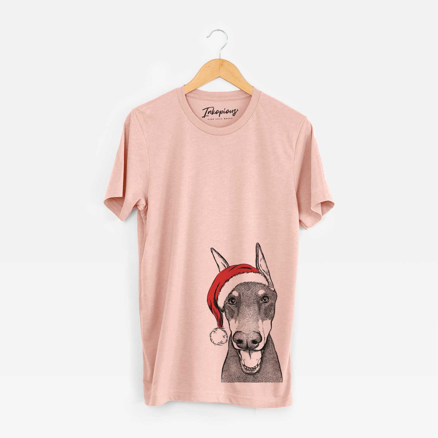 Hand-drawn sketch of Sir Duke the Doberman Pinscher wearing a Santa hat on a Peach Unisex crewneck