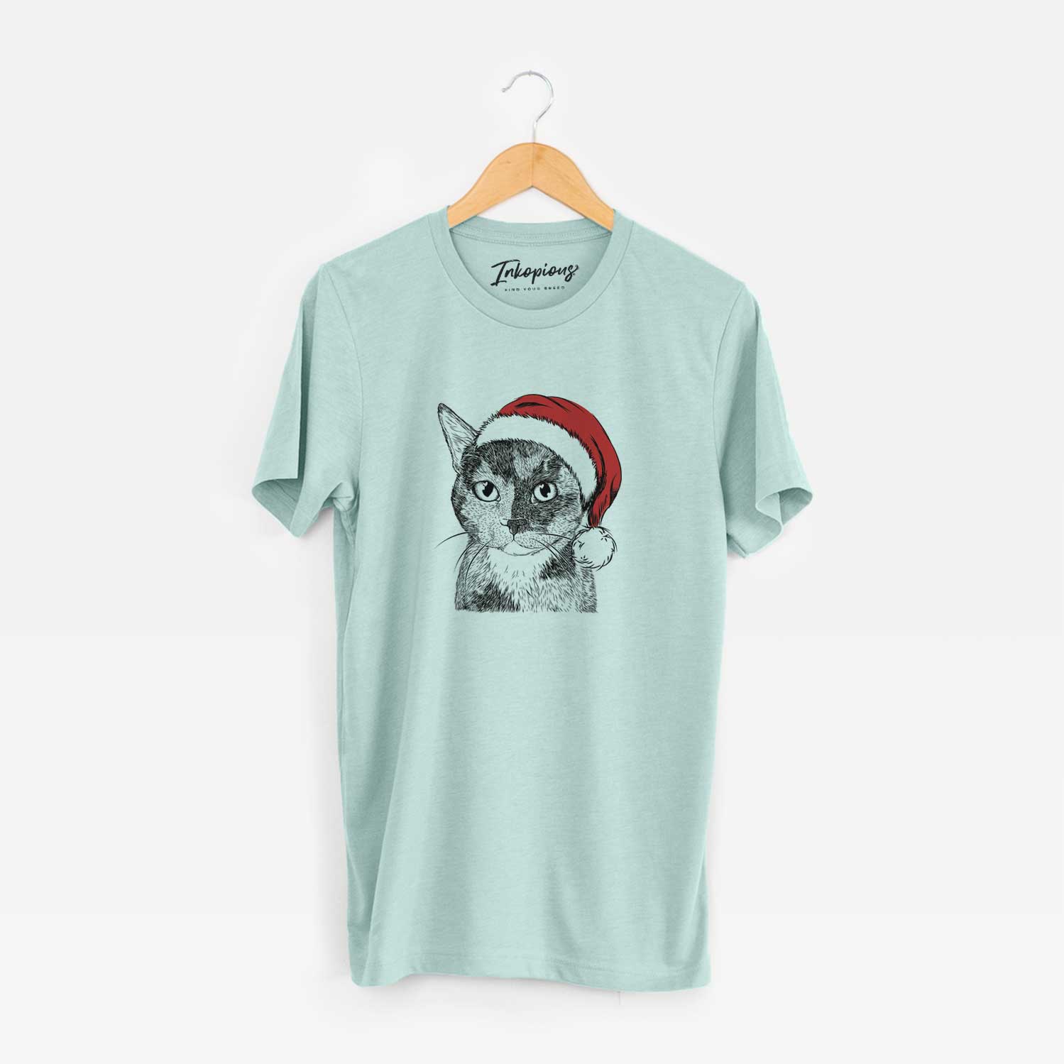 Hand-drawn sketch of Spooky Kitty the Tortoiseshell Cat wearing a Santa hat on a Heather Sage Unisex crewneck