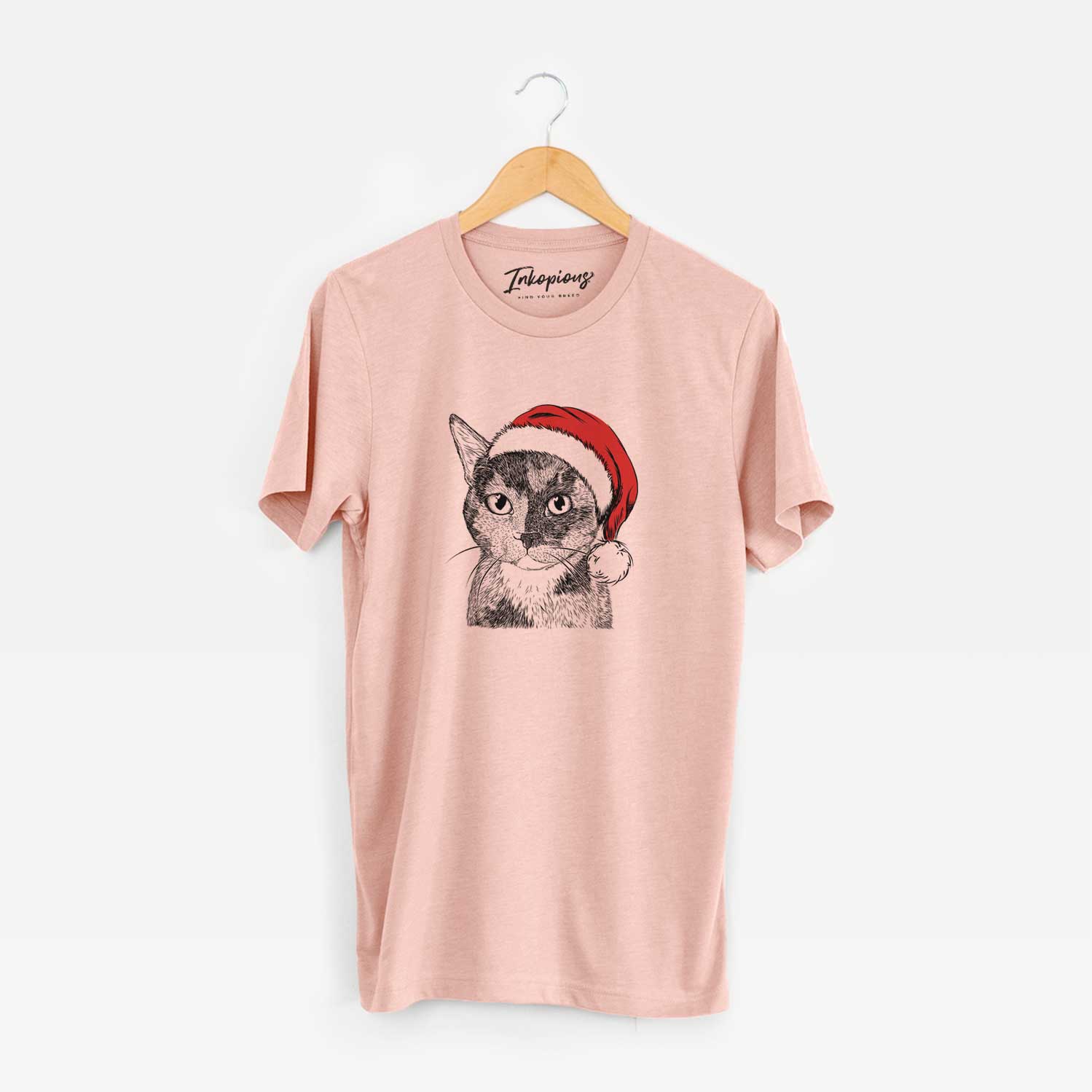 Hand-drawn sketch of Spooky Kitty the Tortoiseshell Cat wearing a Santa hat on a Peach Unisex crewneck