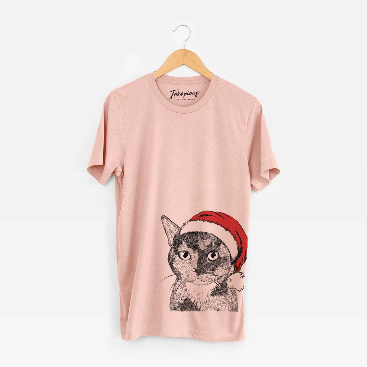 Hand-drawn sketch of Spooky Kitty the Tortoiseshell Cat wearing a Santa hat on a Peach Unisex crewneck