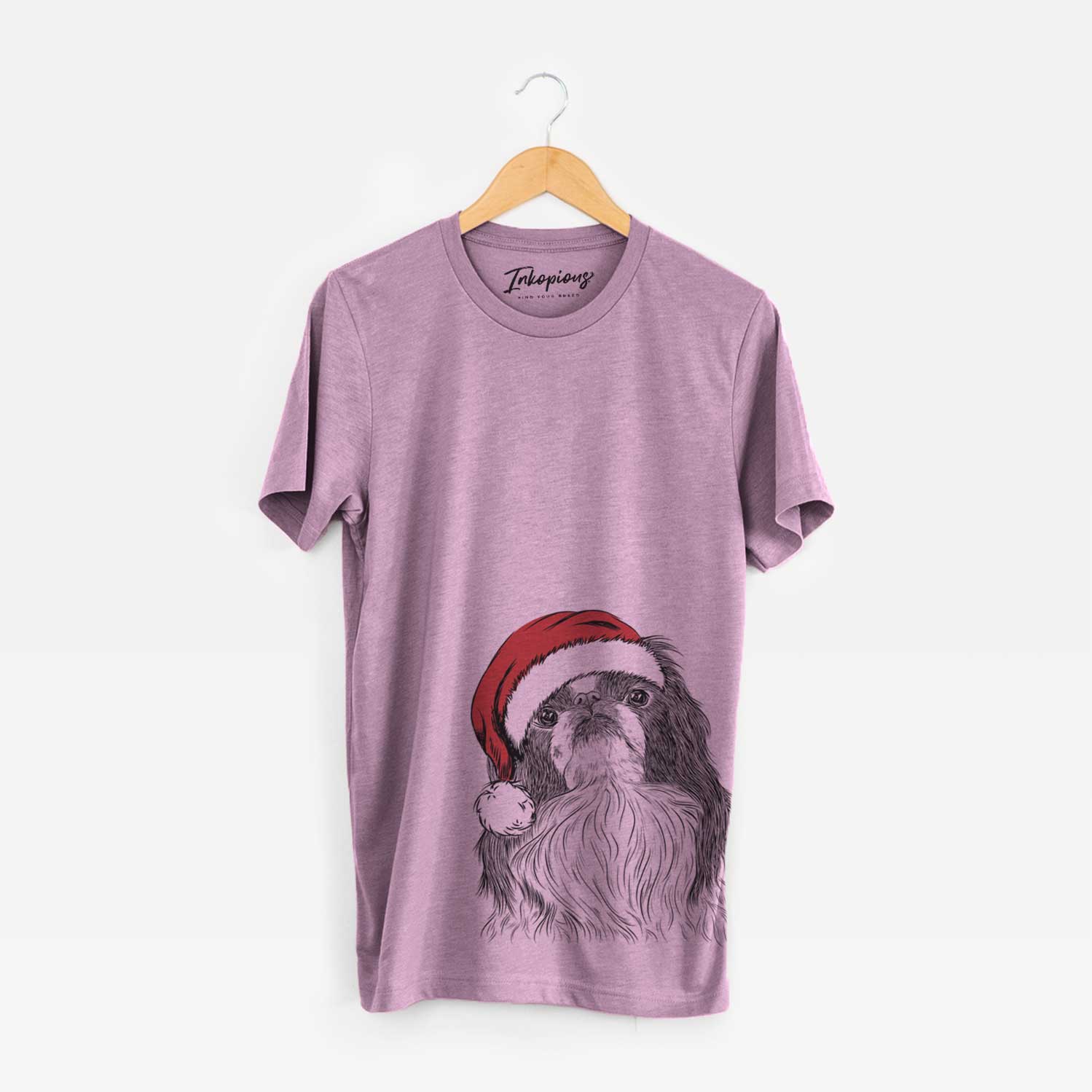 Hand-drawn sketch of Suki the Japanese Chin wearing a Santa hat on an Orchid Unisex crewneck