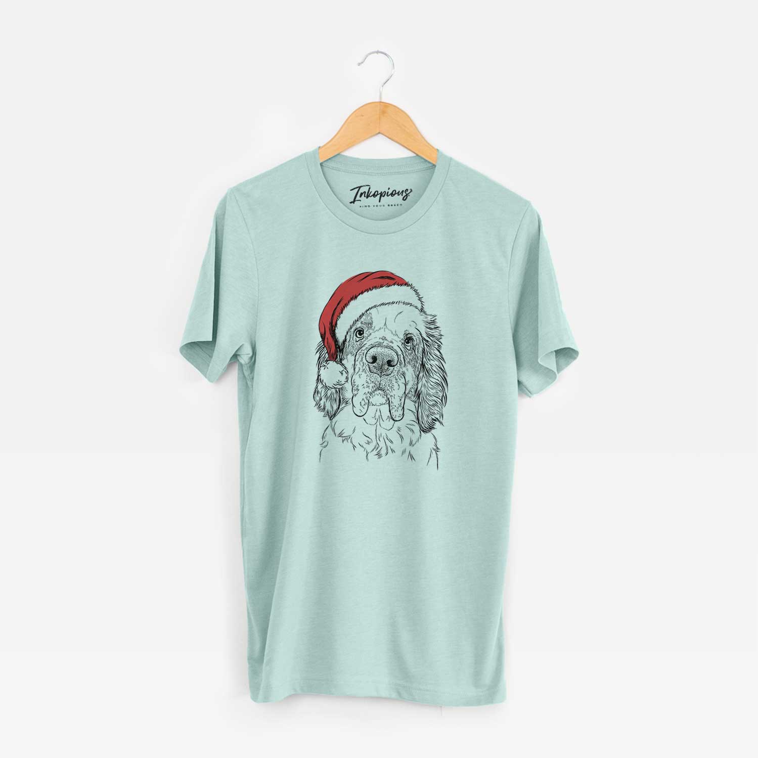 Hand-drawn sketch of Sully the Clumber Spaniel wearing a Santa hat on a Heather Sage Unisex crewneck