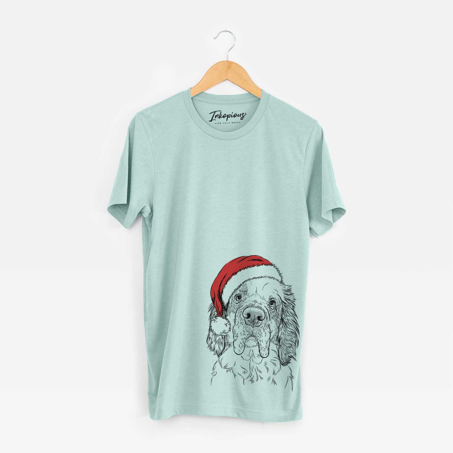 Hand-drawn sketch of Sully the Clumber Spaniel wearing a Santa hat on a Heather Sage Unisex crewneck