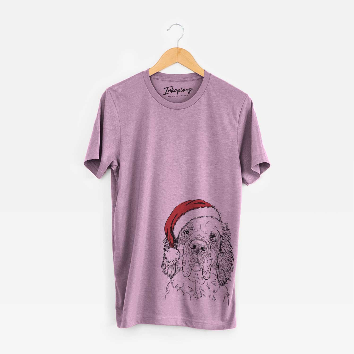 Hand-drawn sketch of Sully the Clumber Spaniel wearing a Santa hat on an Orchid Unisex crewneck